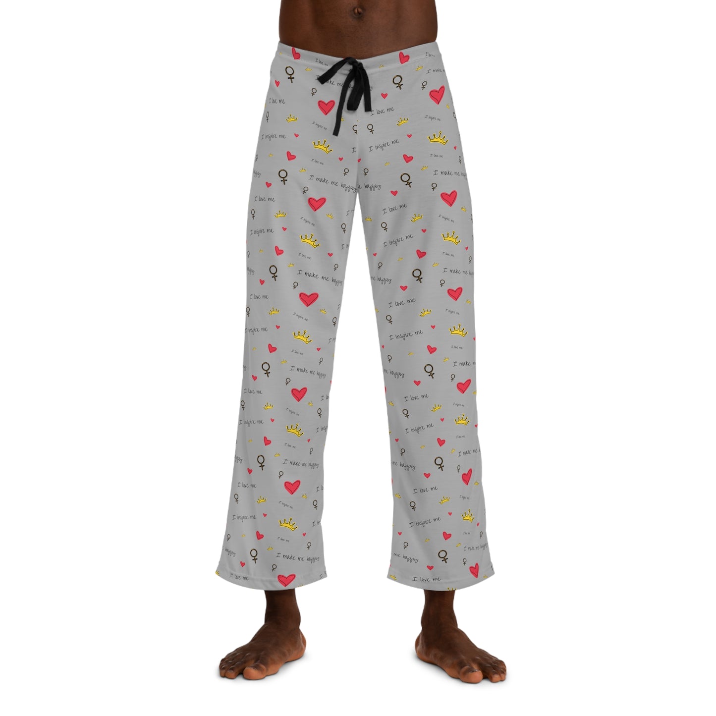 A man wearing grey Printify Men's Pajama Pants with hearts on them, perfect as a Valentine's Day gift.