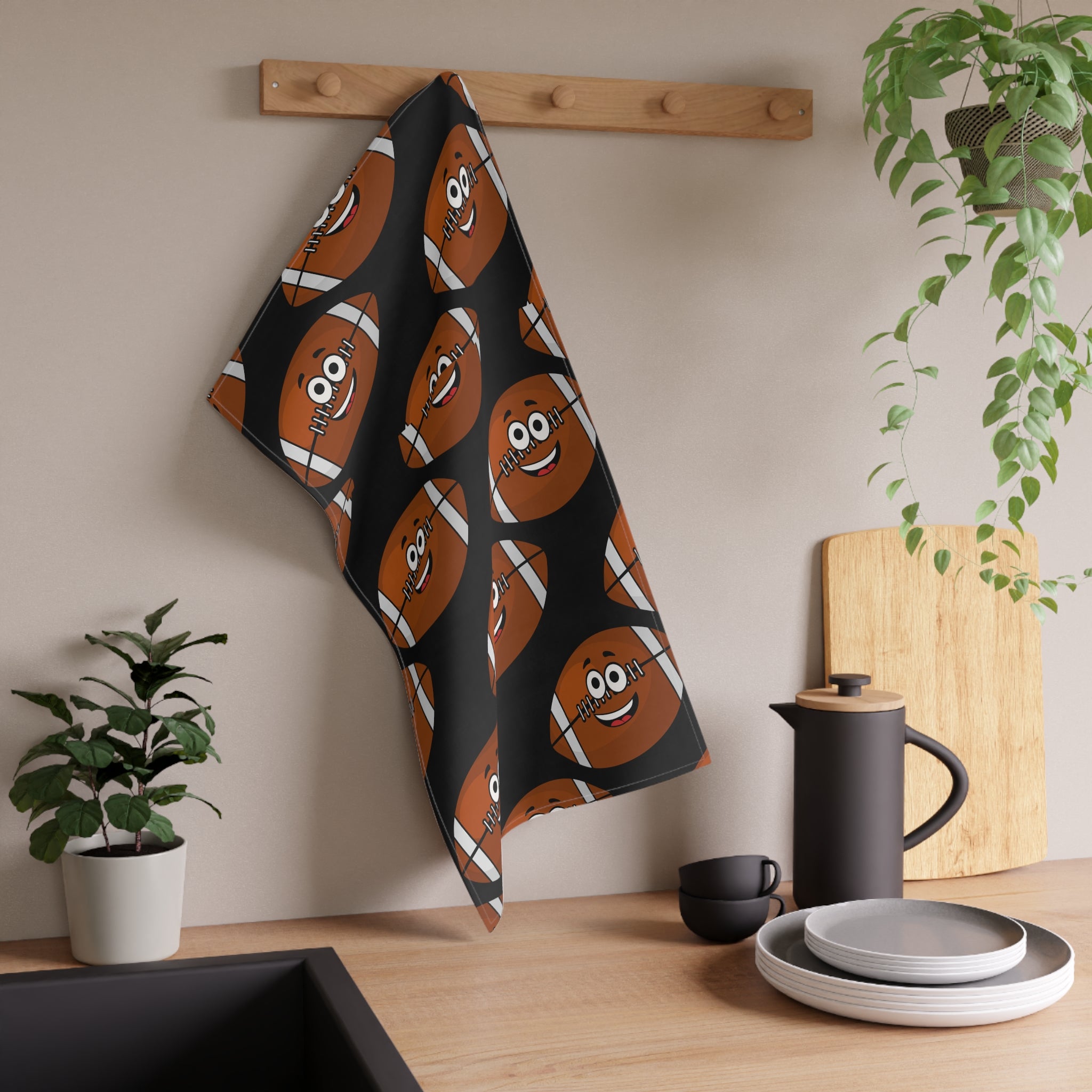 Kitchen towel with cartoon football with smiling faces