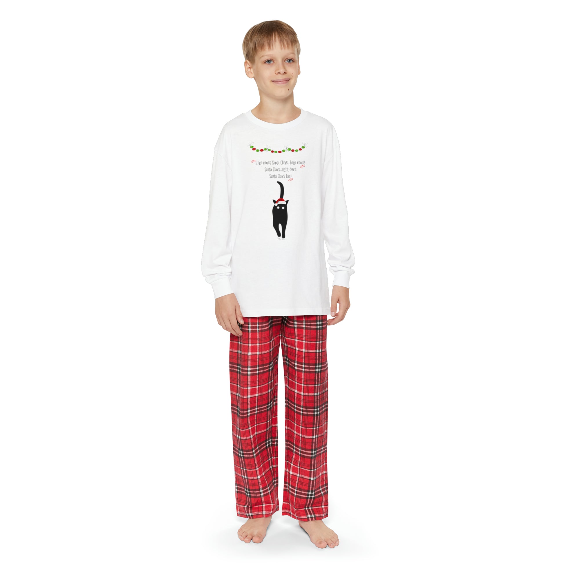 A youth wearing a Printify Matching-Family Youth Pajama-set with a reindeer design made of cotton.