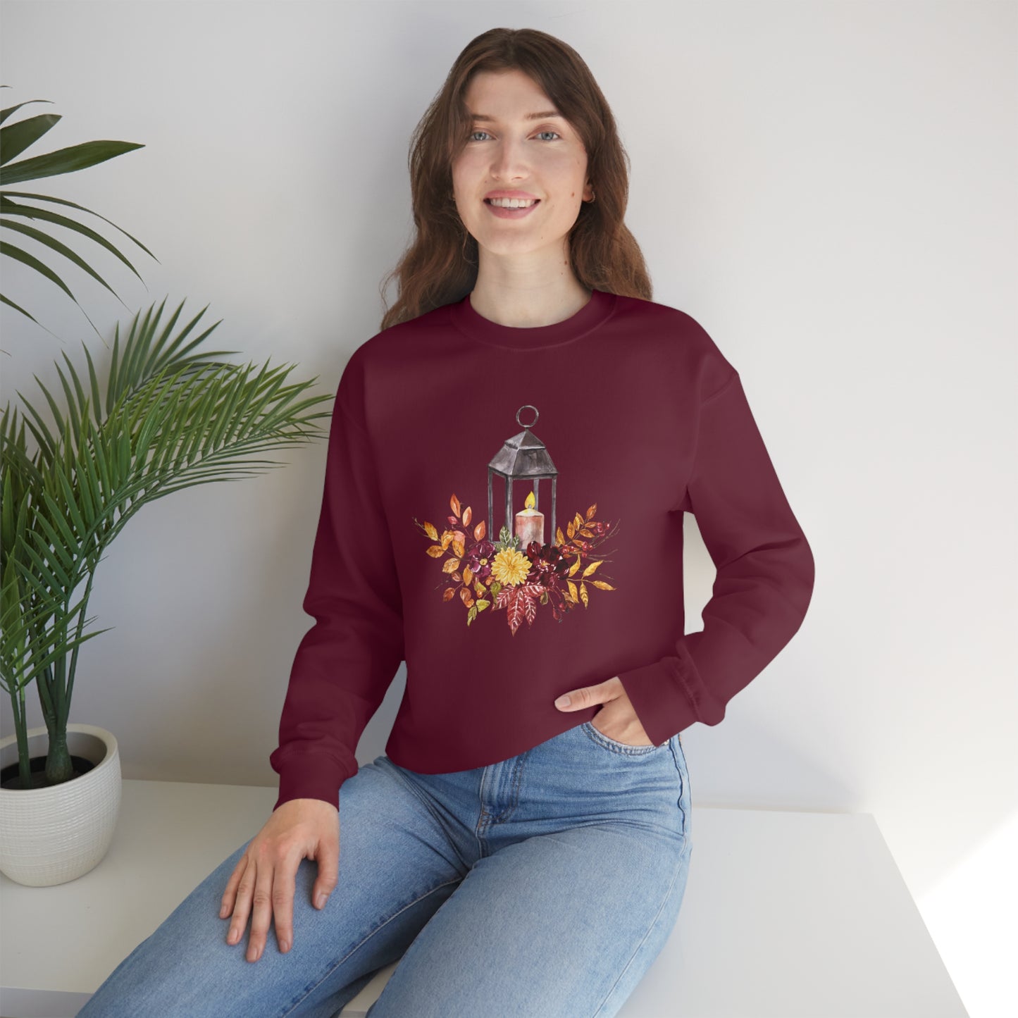 Mock up of a woman sitting on a surface while wearing the Maroon shirt