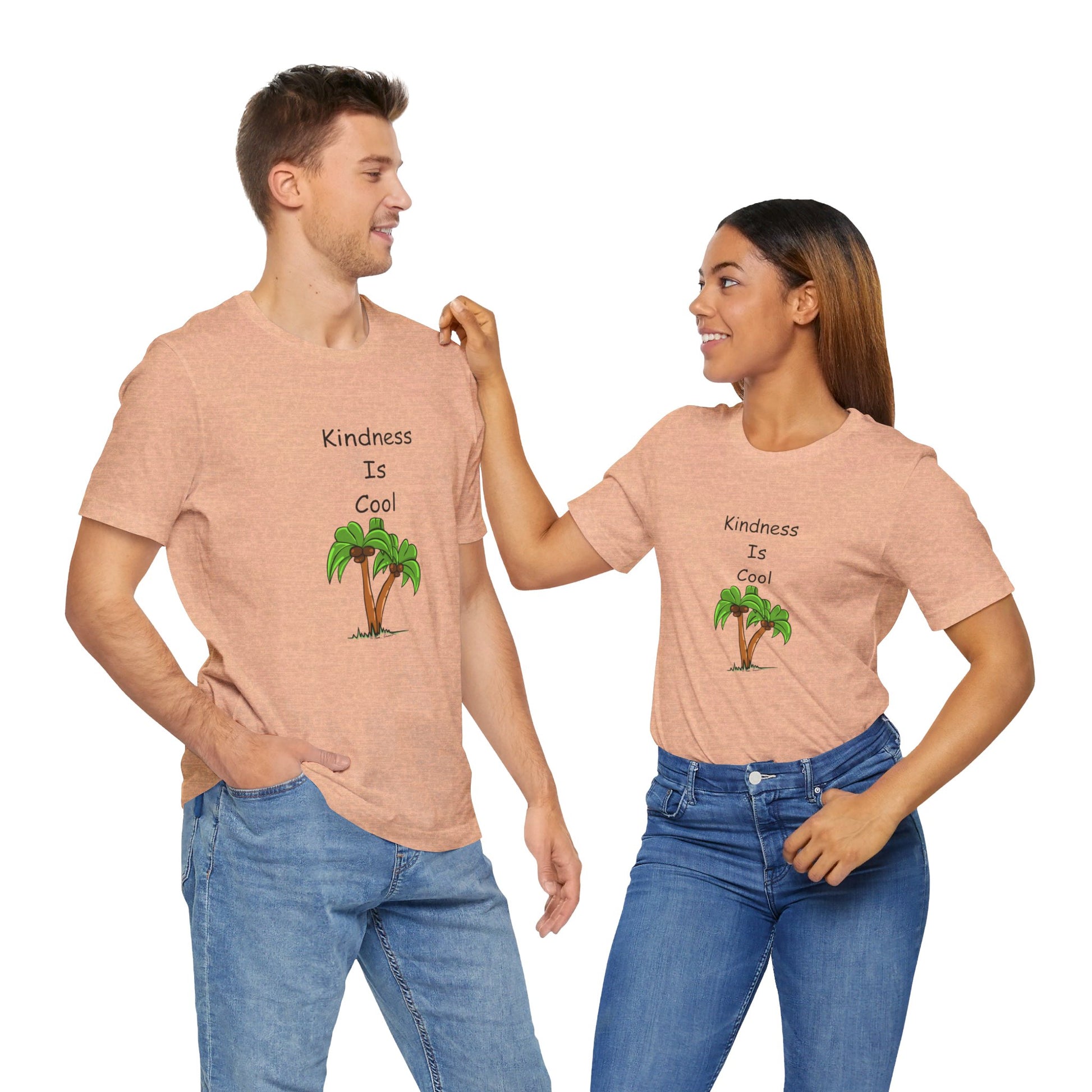 A man and woman are wearing matching Printify Unisex Kindness-Is-Cool T-shirts made from soft Bella+Canvas cotton jersey. The shirts feature a "Kindness is Cool" message along with a palm tree graphic. They are facing each other and smiling.