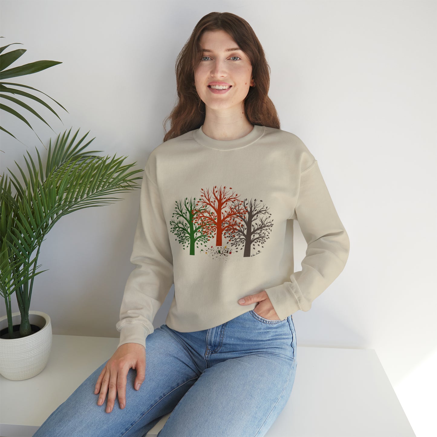 Mock up of a woman sitting on a surface and wearing the Sand shirt