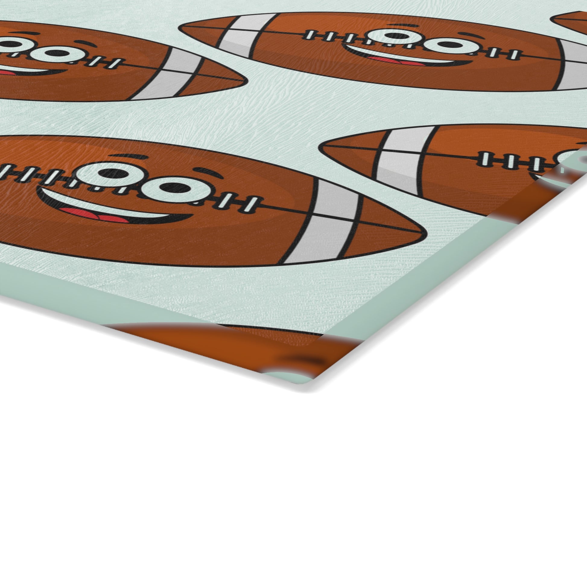 The Playful Football-Faces Cutting Board by Printify features durable glass in 2 sizes with a pattern of cartoon footballs—ideal for fun, decorative kitchen style.