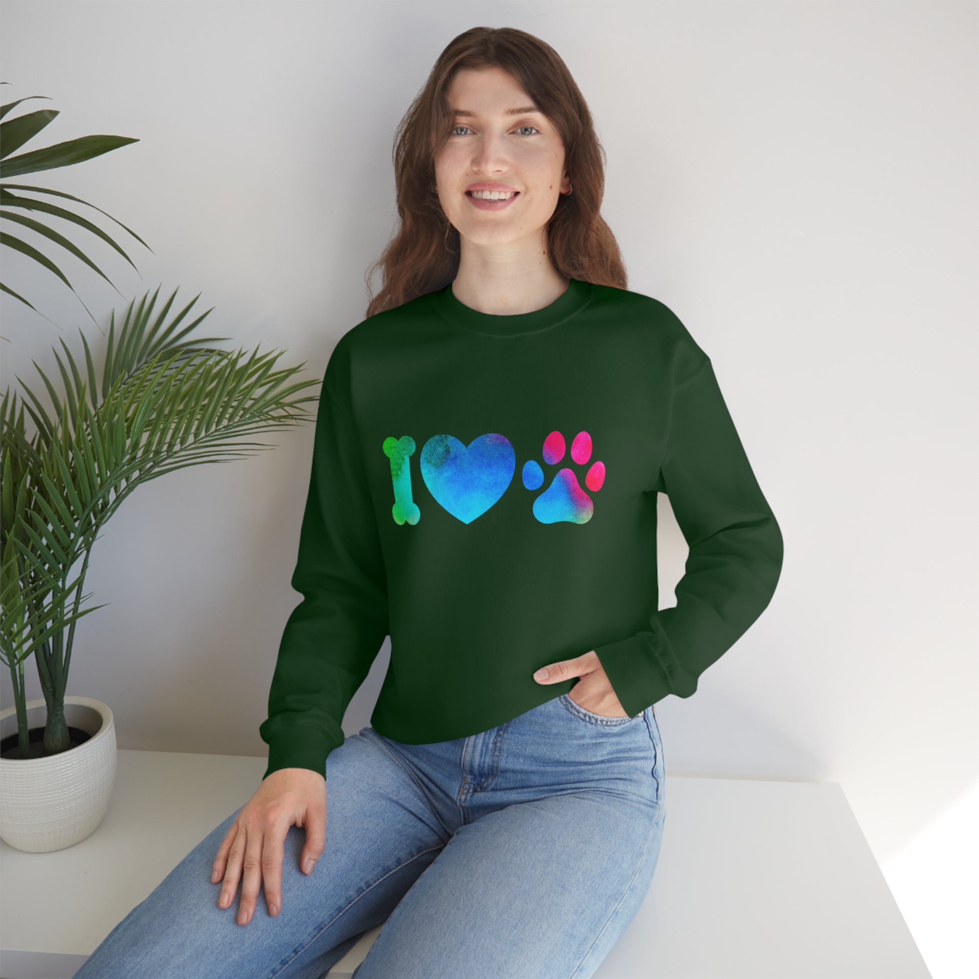 Mock up of a woman wearing the Forest Green sweatshirt while sitting on a surface