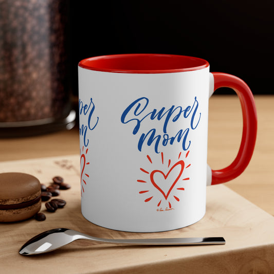 Mug on a surface next to a spoon and a cookie