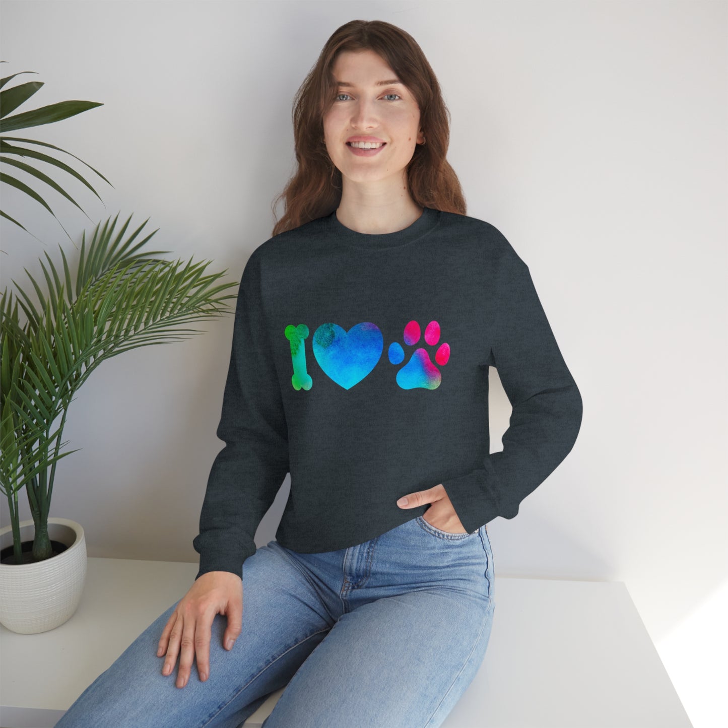 Mock up of a woman sitting on a surface and wearing the Dark Heather sweatshirt