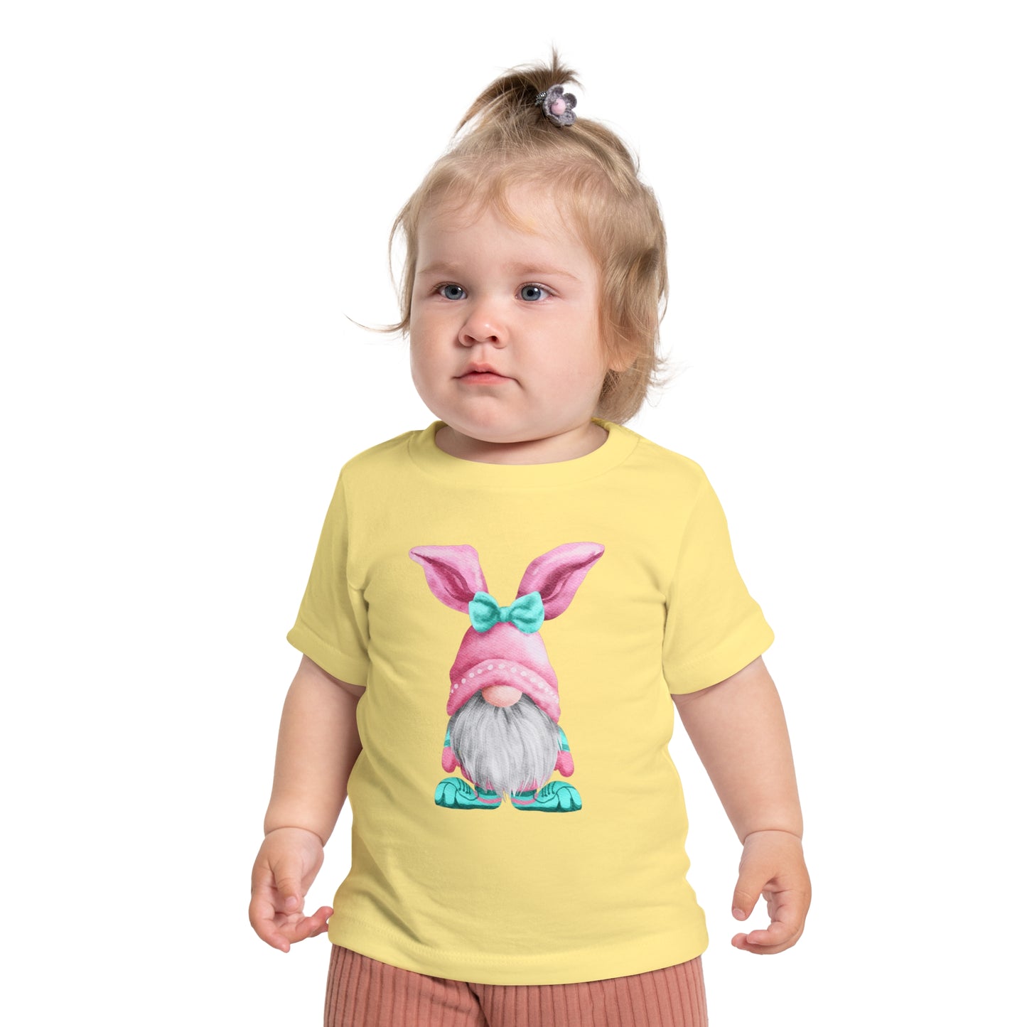 Toddler in a Printify Baby's Easter-Gnome T-shirt featuring a cartoon bunny print, looking to the side.