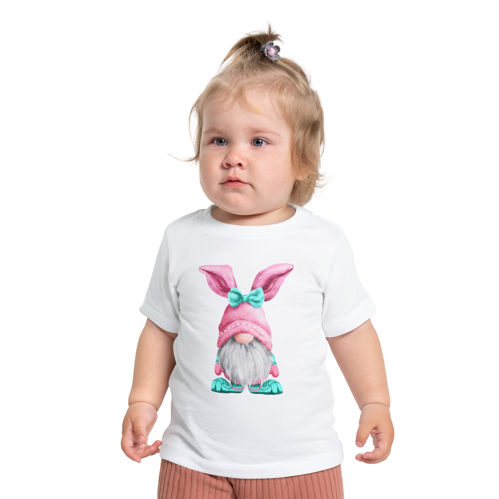 Toddler in a Baby's Easter-Gnome T-shirt: Unisex; Cotton; Bella + Canvas, by Printify, looking slightly to the side.