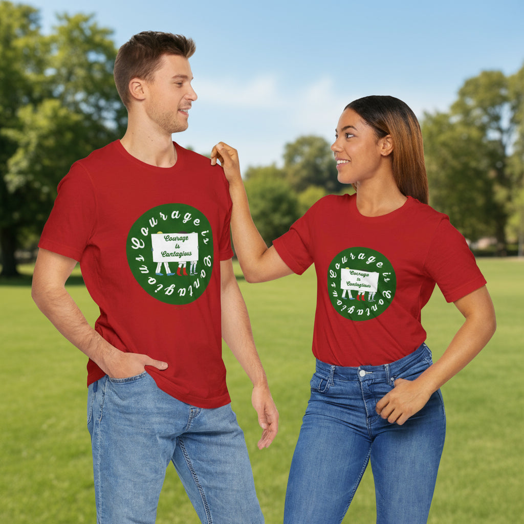 Two people stand outdoors in matching Printify Courage Is Contagious T-shirts: a unisex activist graphic tee with a green circle and uplifting message, perfect for a sunny day surrounded by nature.