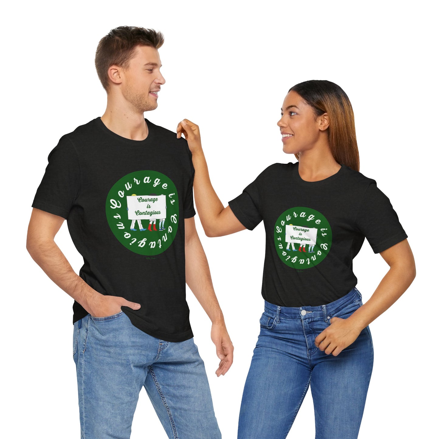 A man and woman smile at each other while wearing matching black Printify Courage Is Contagious T-shirts from Activist Graphics, featuring a green circular logo and text.