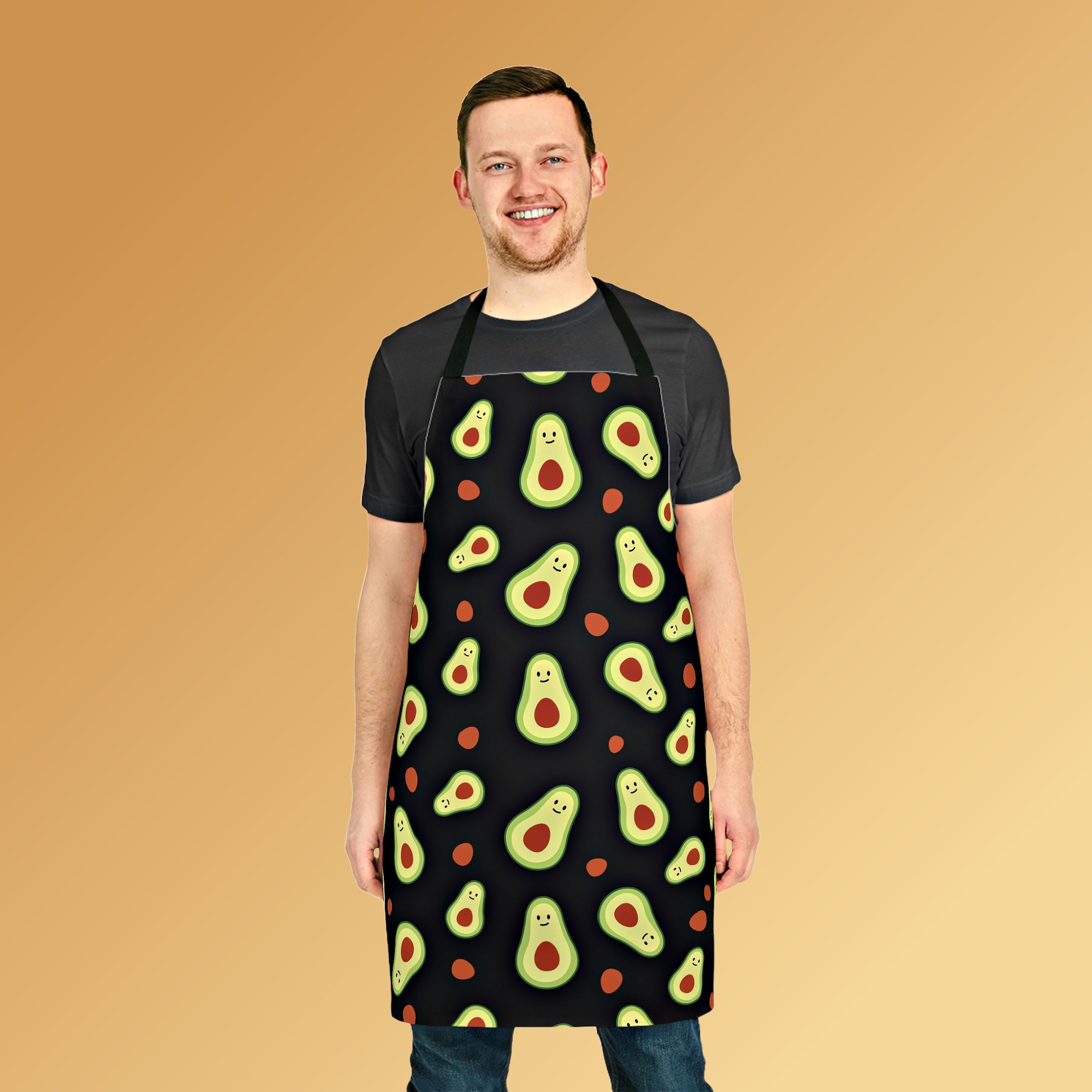 Man wearing the black unisex apron with an all-over print of avocado halves