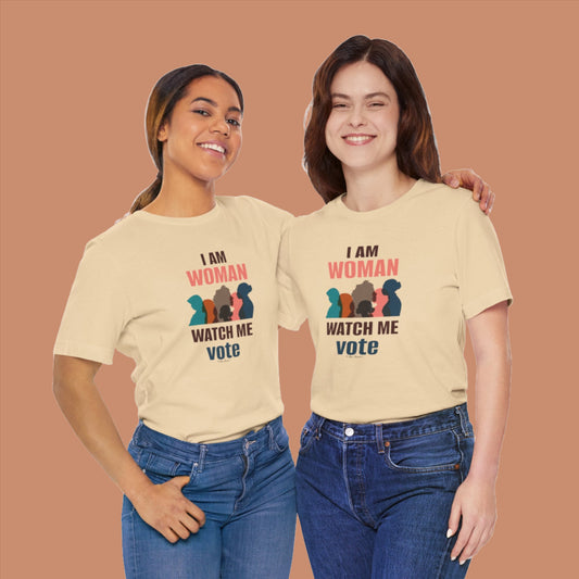 Two women wearing beige Printify Bella + Canvas Voting Women's T-shirts with "i am woman watch me vote" printed on them, smiling and posing side by side.