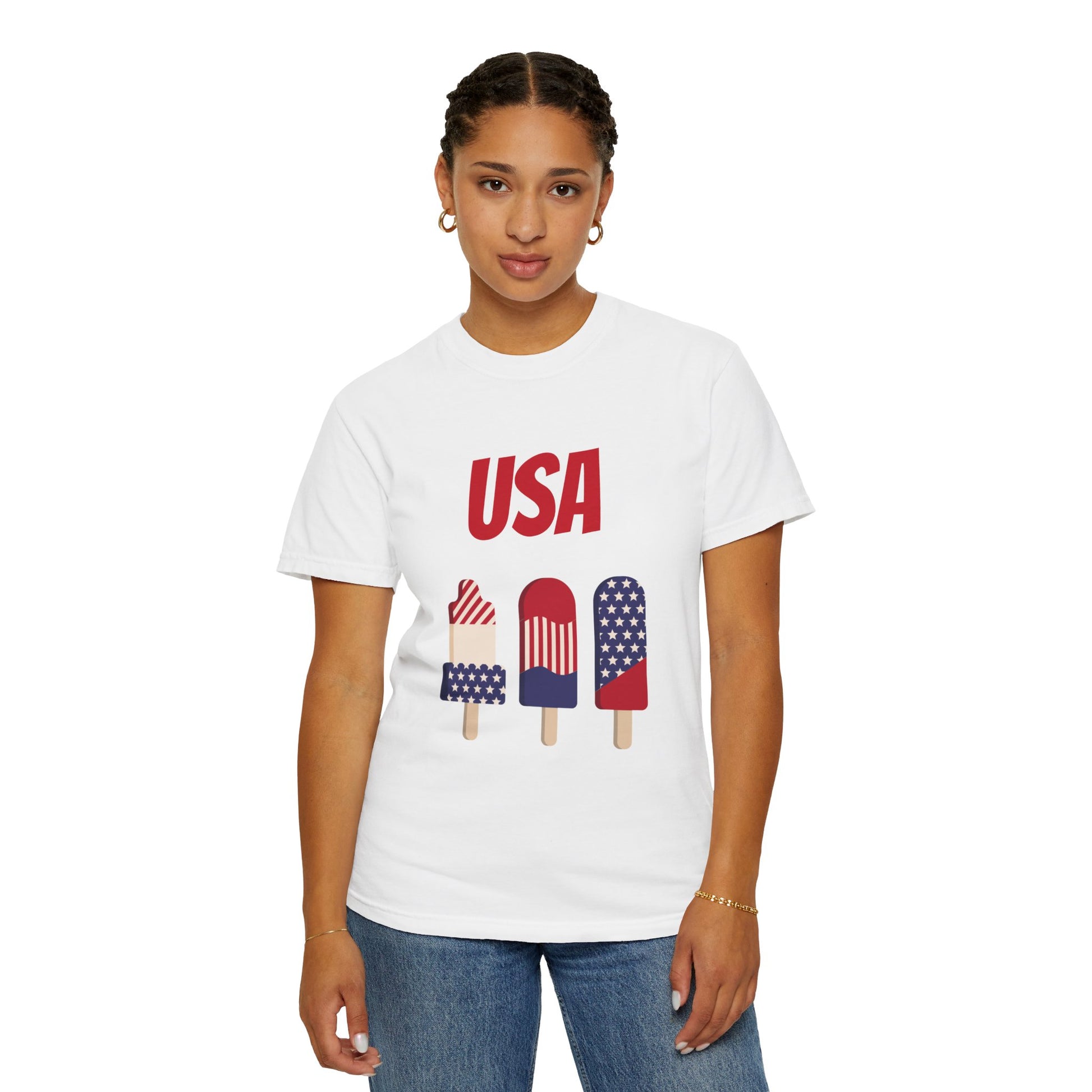 Person wearing a white Printify Unisex USA T-shirt: 3 colors; Cotton; Comfort Colors 1717, made from 100% ring-spun cotton, featuring "USA" and three popsicles decorated in patriotic colors printed on it.