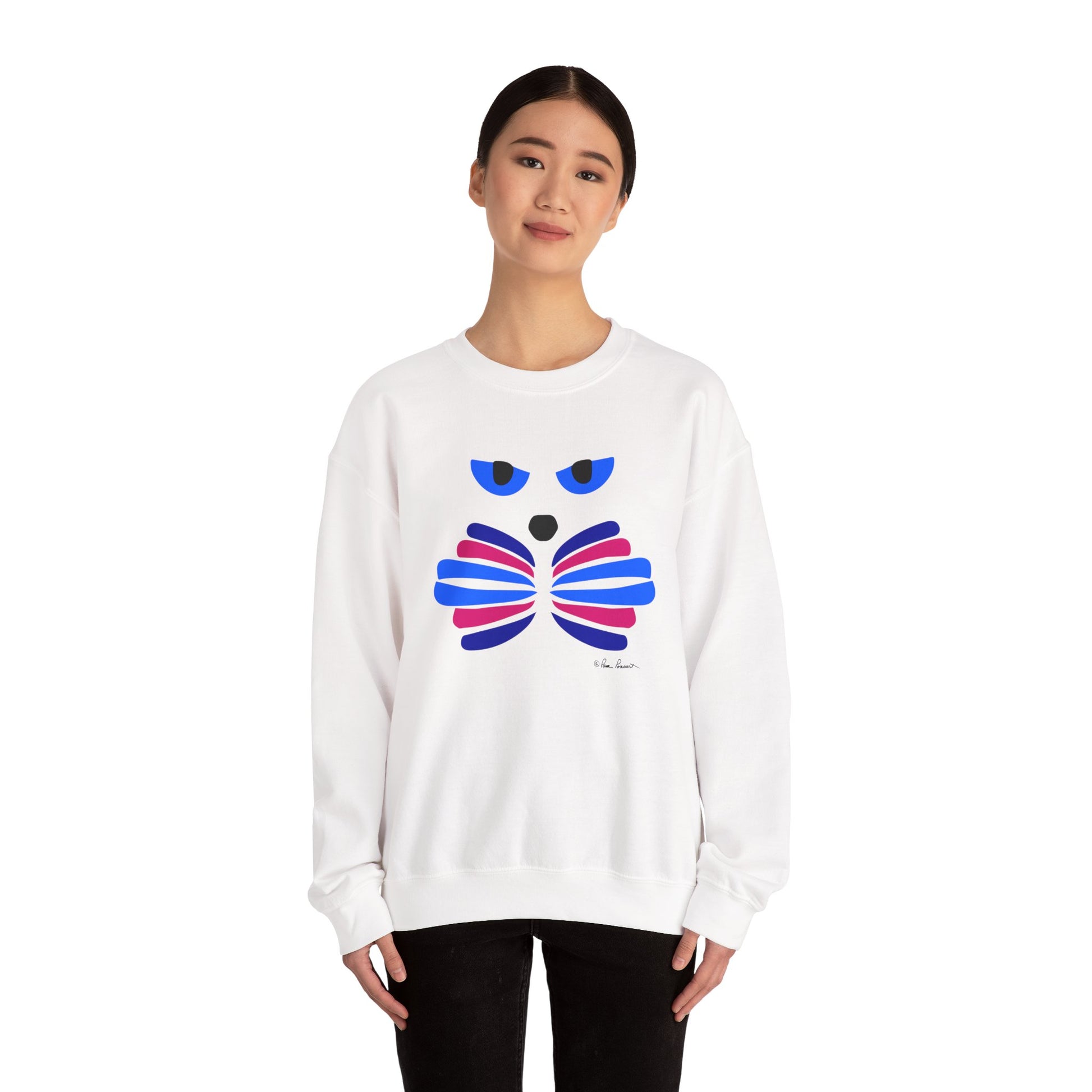 A woman faces forward wearing the Printify Whimsical Cat Graphic Sweatshirt, a cozy unisex crewneck featuring playful cat art on the front, paired with black pants.