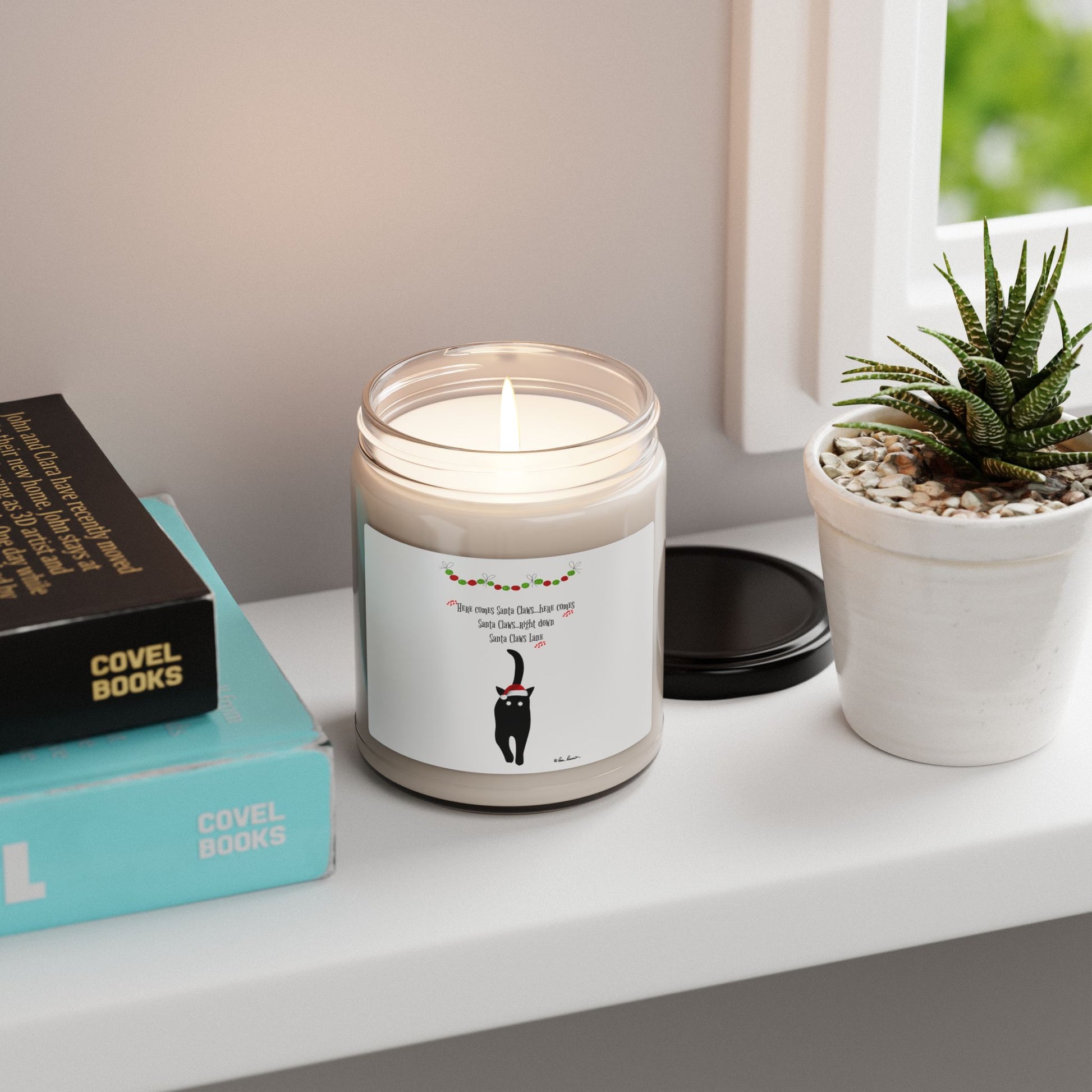 The Festive-Cat Scented Soy Candle by Printify (9oz) features a charming cat design in a glass jar, making it perfect holiday home decor for cozy, eco-friendly spaces. Display on a windowsill with books and plants for extra charm.