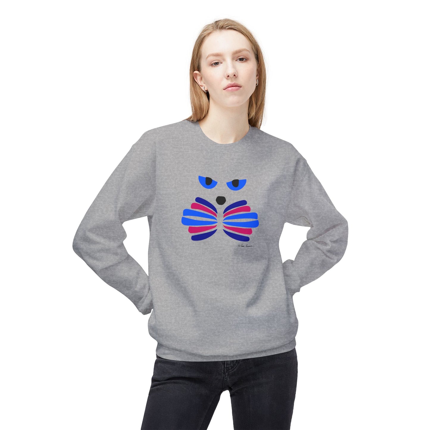 A person wearing the Printify Cat Face Crewneck Sweatshirt: Abstract Red & Blue Kitty, crafted in a cozy cotton blend with an abstract red and blue cat face graphic, stands with hands on hips.