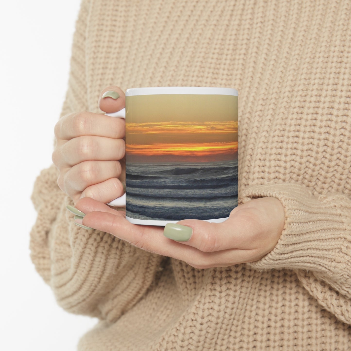 Mock up of the mug being held by a woman wearing a sweater