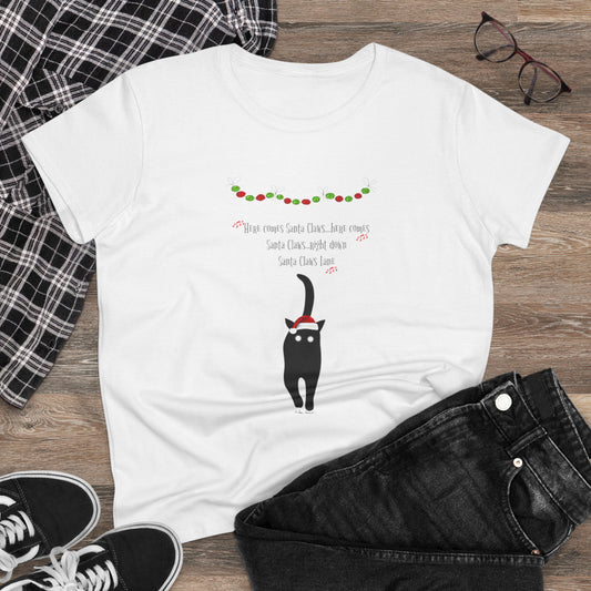 The Santa Claws T-shirt by Printify, a festive and playful women’s cotton tee featuring a cartoon black cat in a Santa hat and holiday lights, is the perfect holiday shirt to style with black jeans and sneakers this season.