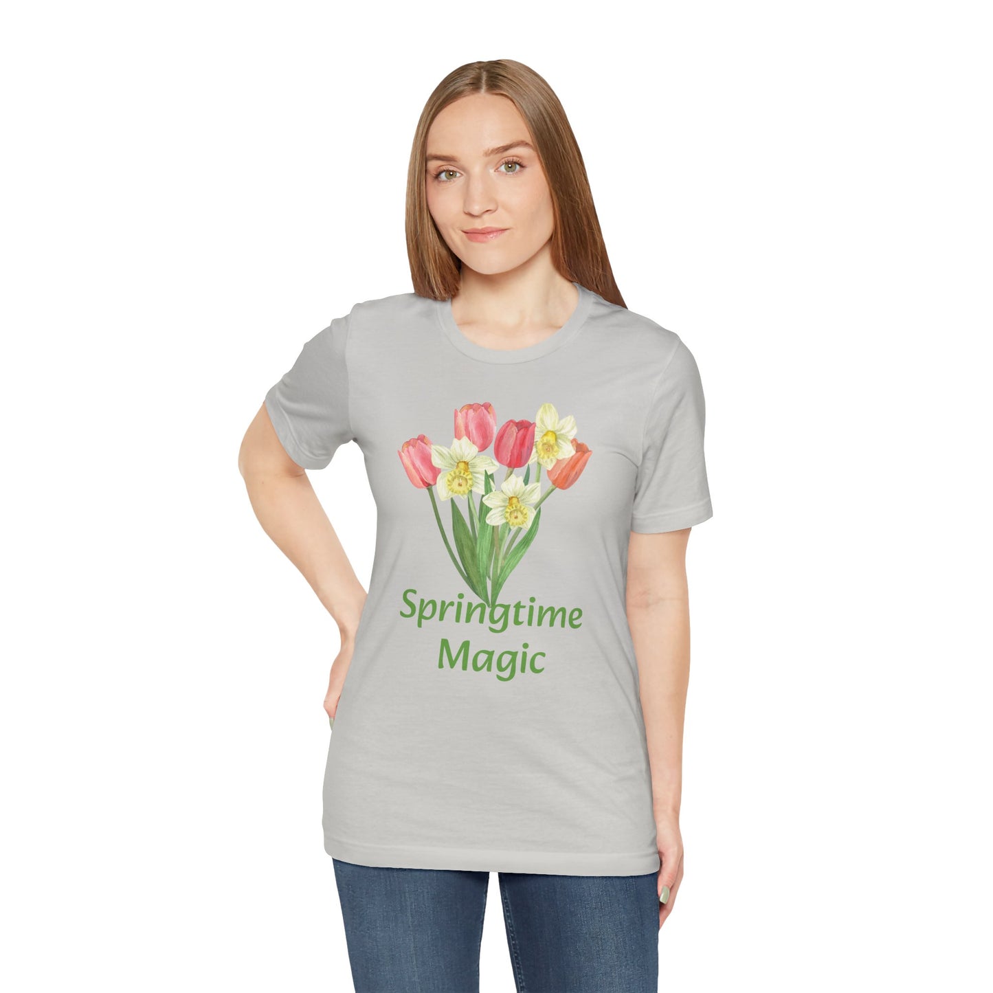 Woman wearing a Unisex Springtime-Magic T-shirt in cotton gray with a tulip print and the phrase "springtime magic" by Bella + Canvas.