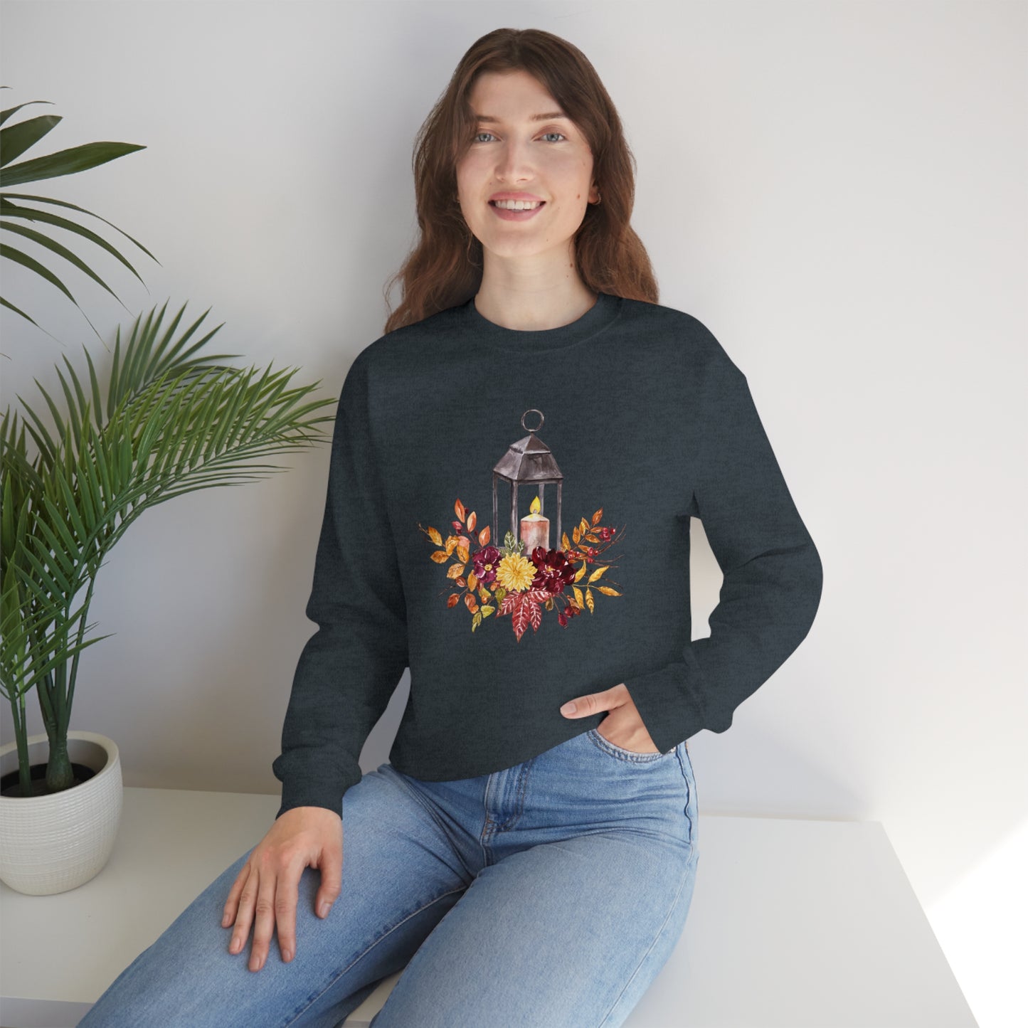Mock up of a woman sitting on a surface while wearing the Dark Heather shirt