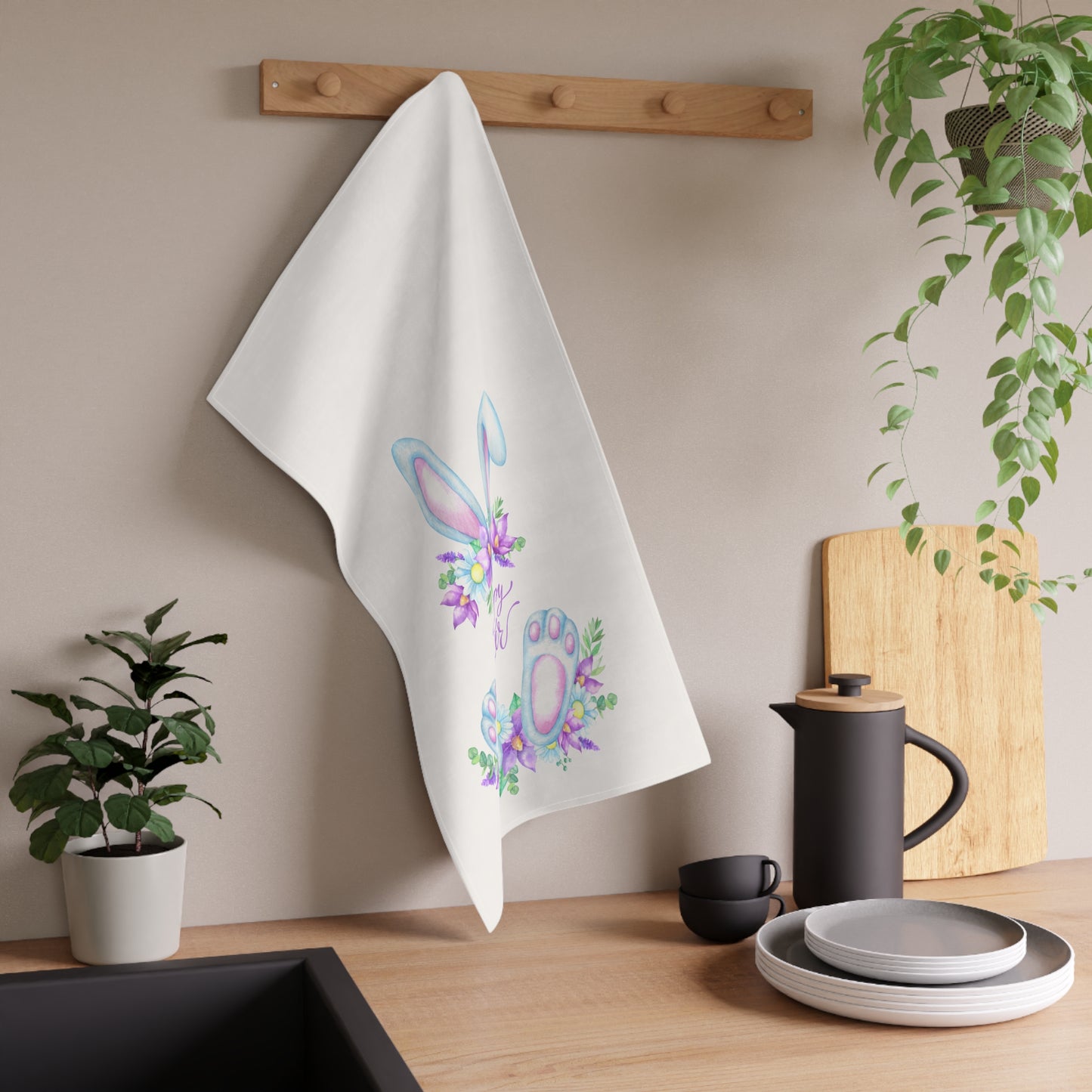 An absorbent Printify Easter Greeting Towel with a floral design is hanging in the kitchen.