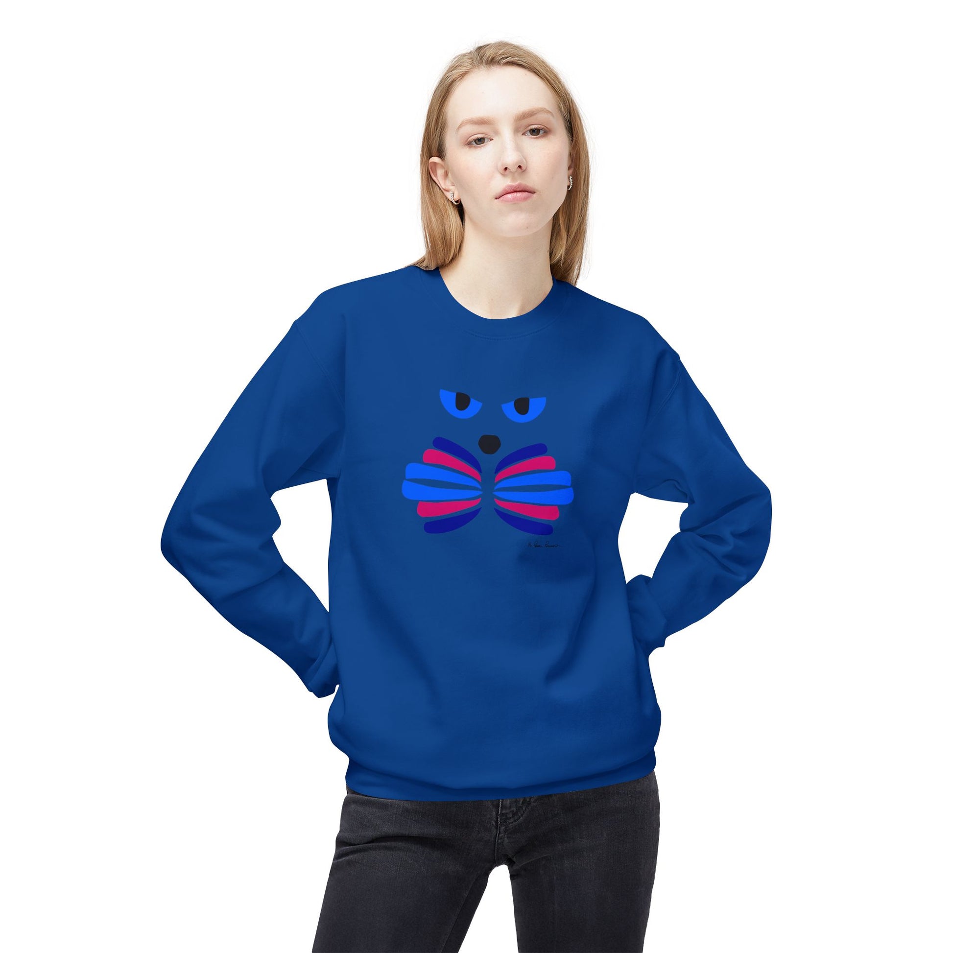 A person wearing the Printify Cat Face Crewneck Sweatshirt: Abstract Red & Blue Kitty, featuring a stylized cat face design, stands with hands behind their back.