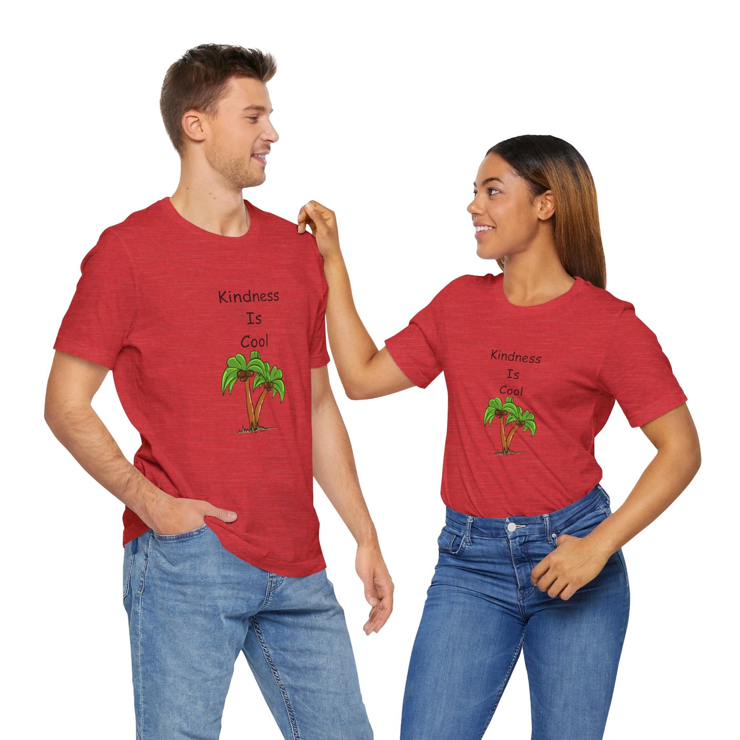 A man and woman, both wearing matching Unisex Kindness-Is-Cool T-shirts by Printify, featuring soft cotton jersey from Bella+Canvas with the text "Kindness Is Cool" and a palm tree graphic, smile at each other.