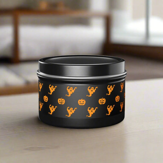 A black tin container embellished with orange Halloween-themed patterns of ghosts and pumpkins rests on a table, showcasing Printify's Halloween Tin Candles made from soy wax, enveloping the air in delightful seasonal fragrances.