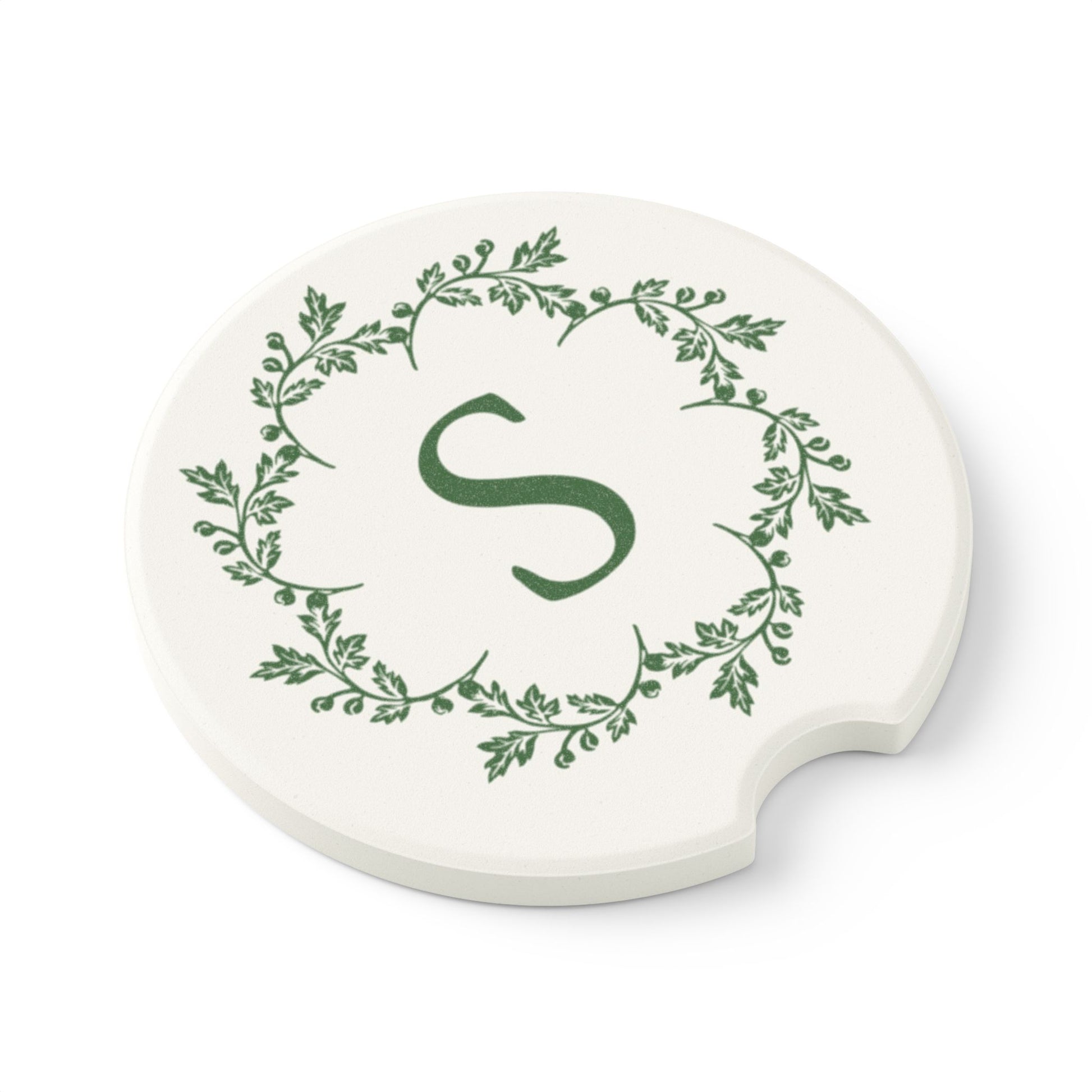 Printify's Personalized Car Coasters feature an elegant design with a round ceramic build, showcasing a green letter "S" in the center surrounded by a leafy vine pattern. These stylish and absorbent coasters are perfect for adding both functionality and flair to your vehicle's interior.