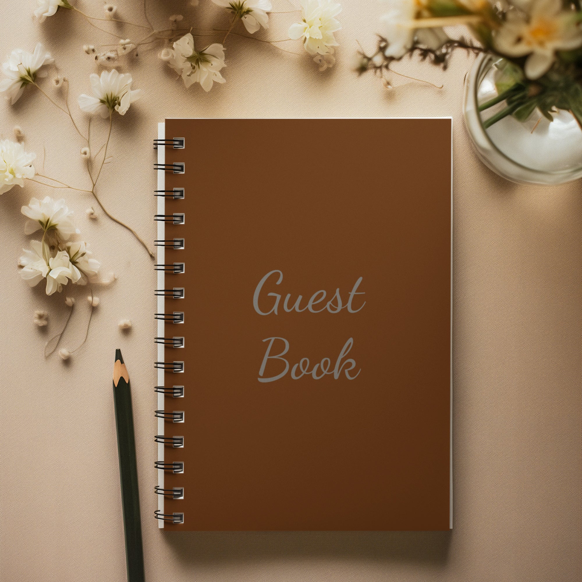 AI-created mock up of the brown Guest Book laying next to a pencil and some flowers