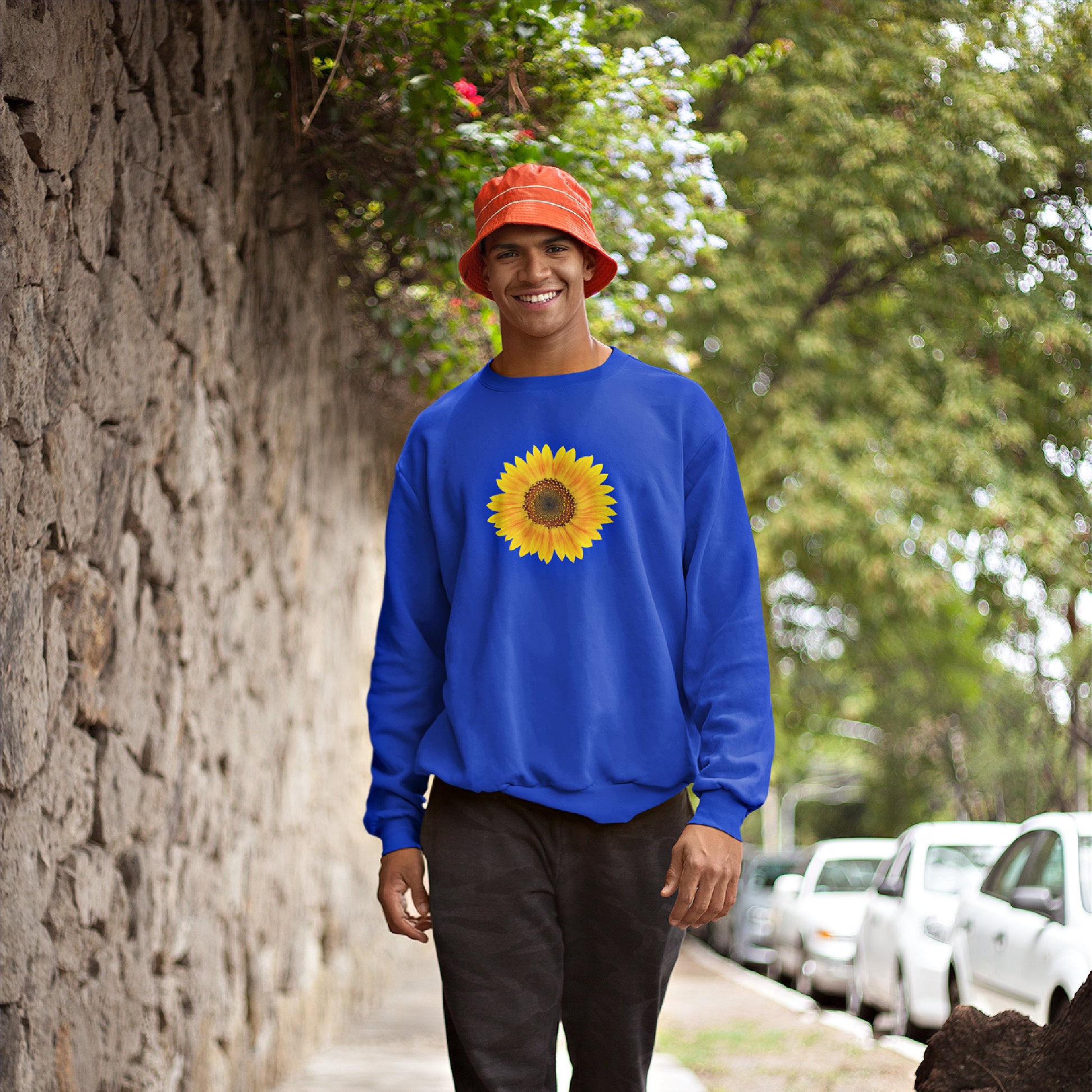 Mock up of a happy man walking down the street and wearing the  Royal blue sweatshirt