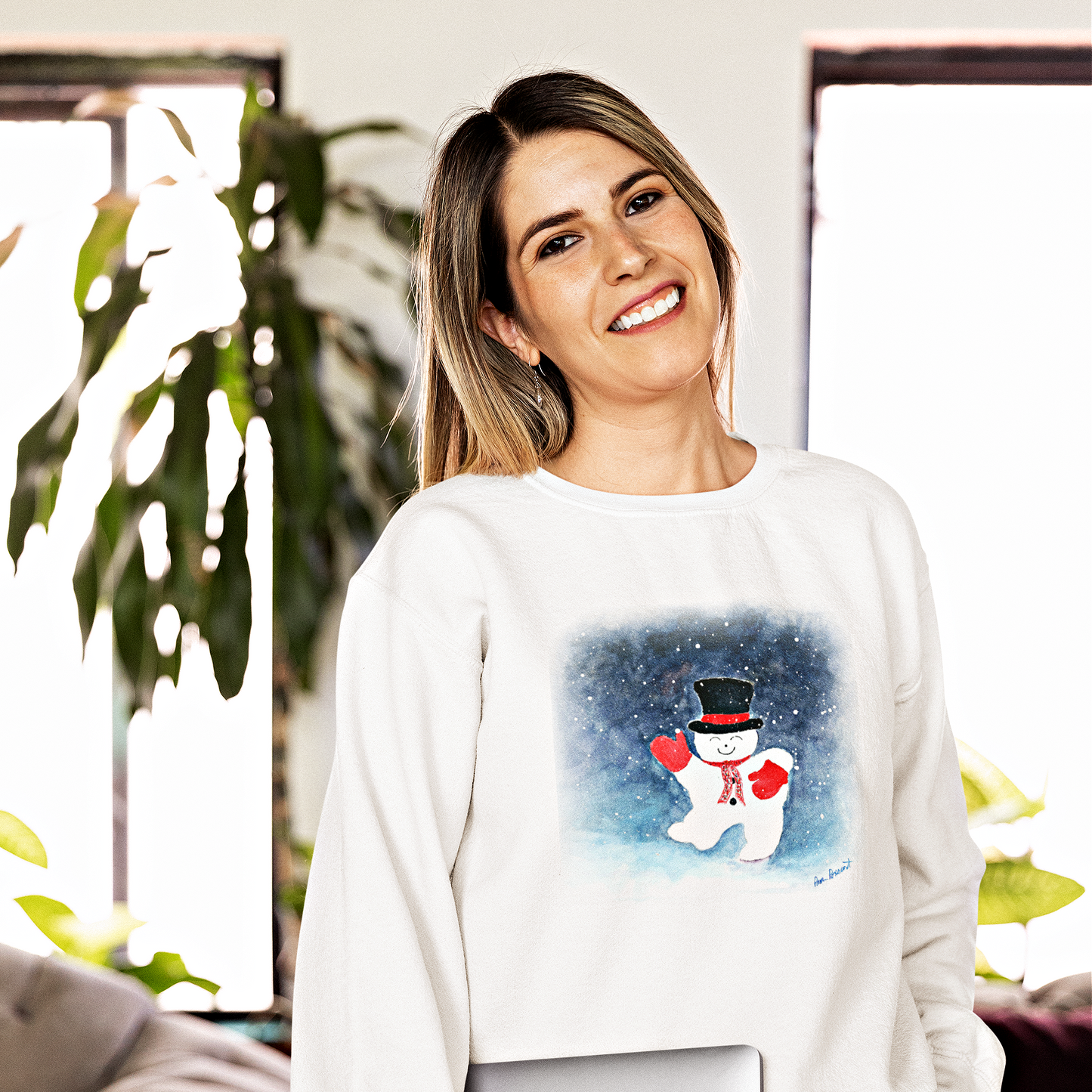 Woman wearing white sweatshirt with dancing snowman on front