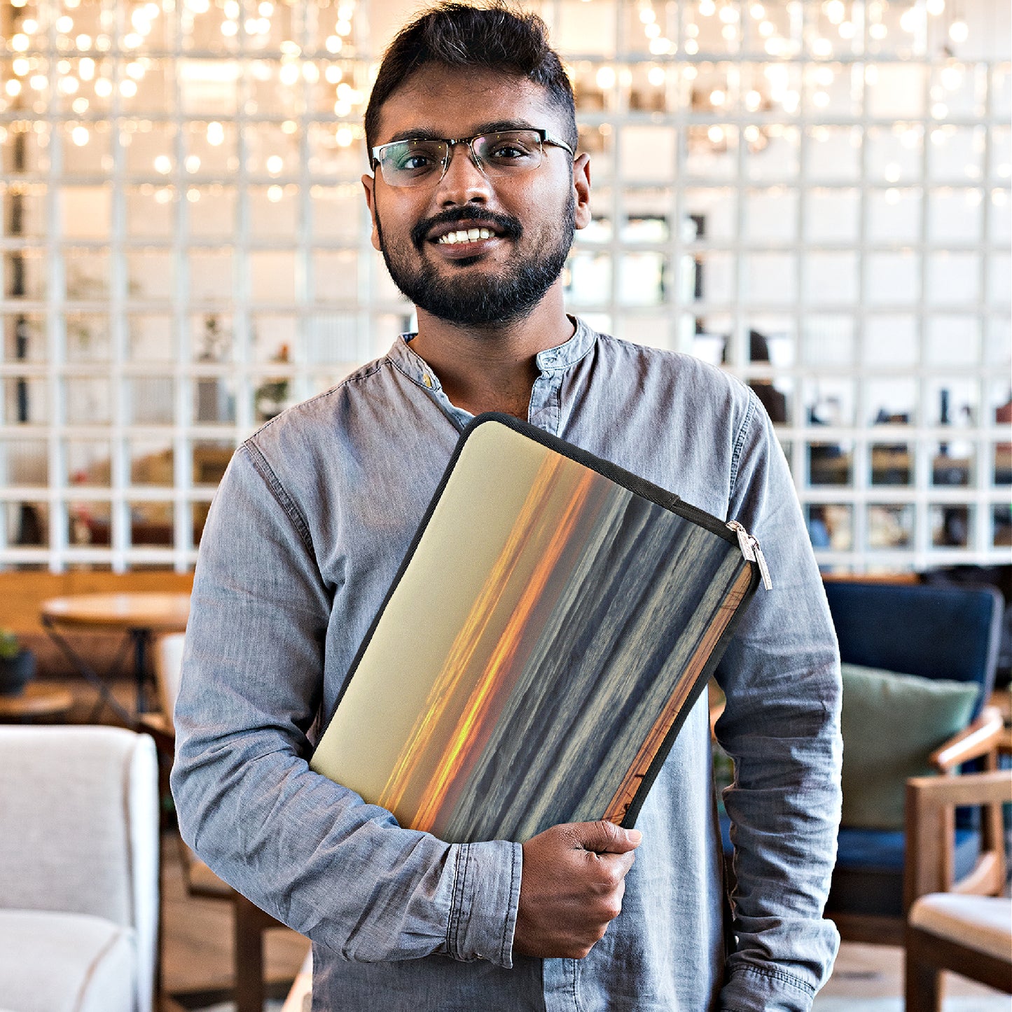 Mock up of a bearded man carrying his computer laptop inside of our sleeve