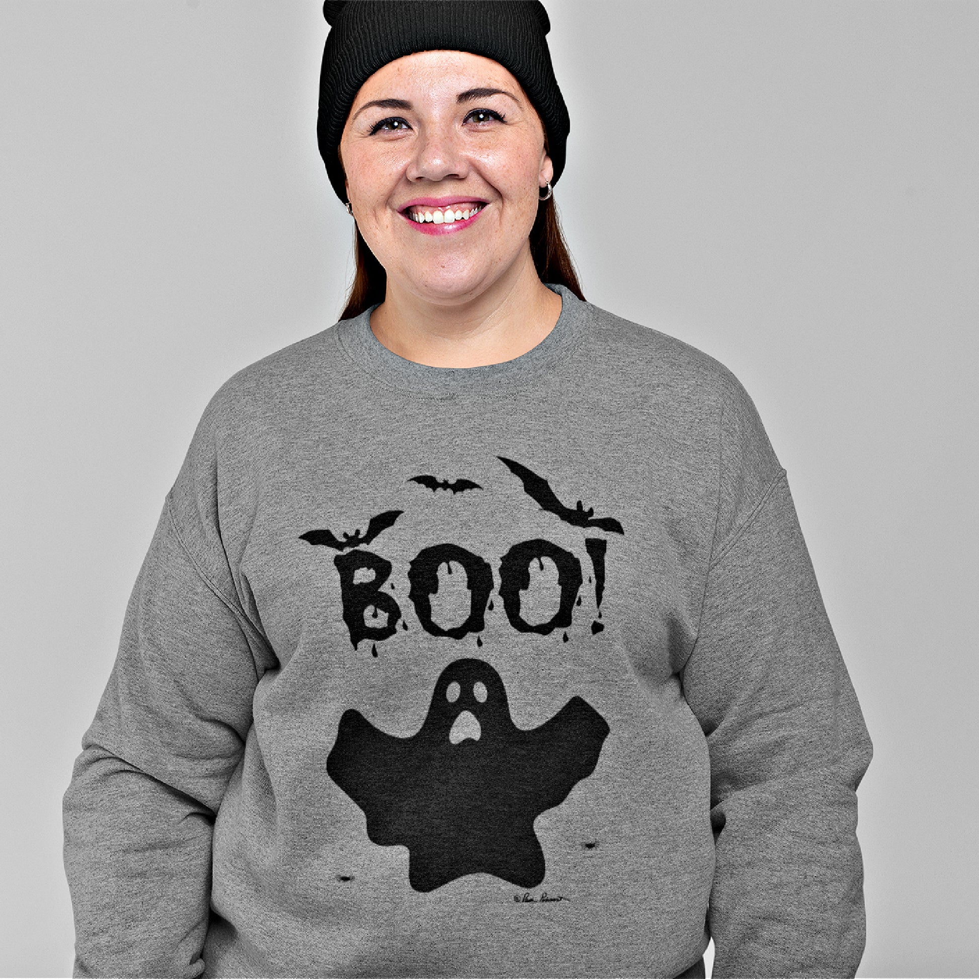 Mock up of large woman wearing a black beanie and our grey sweatshirt