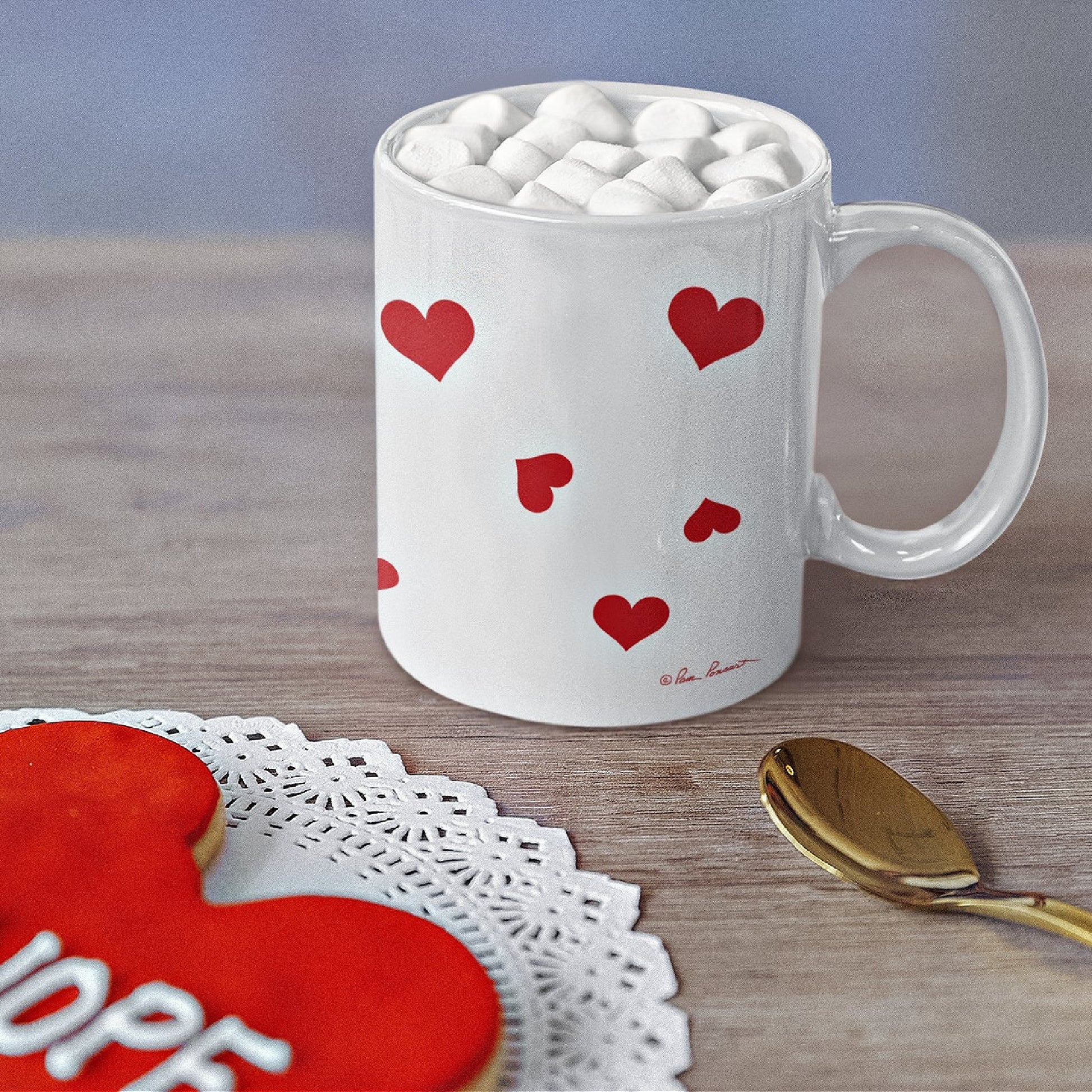 Mock up of our Valentine Love Mug on a table next to a red cookie