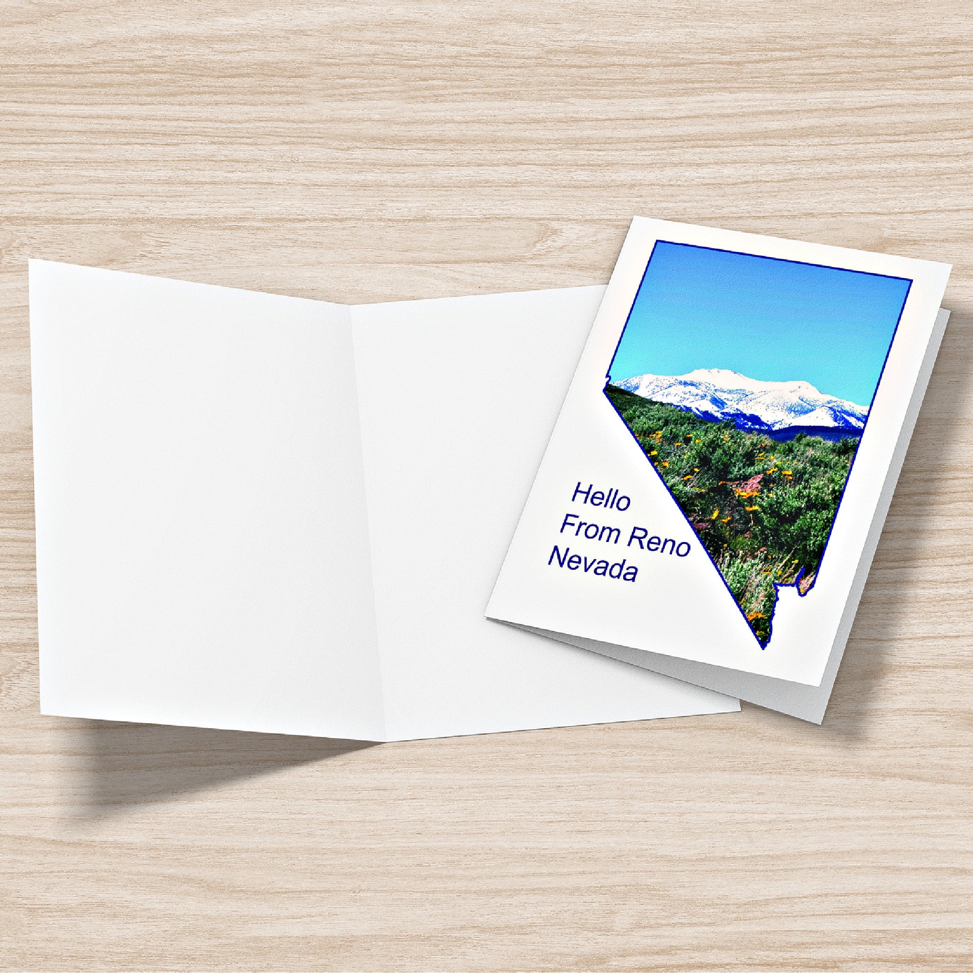 Mock up of our Hello From Reno greeting card front and a blank inside view on a table