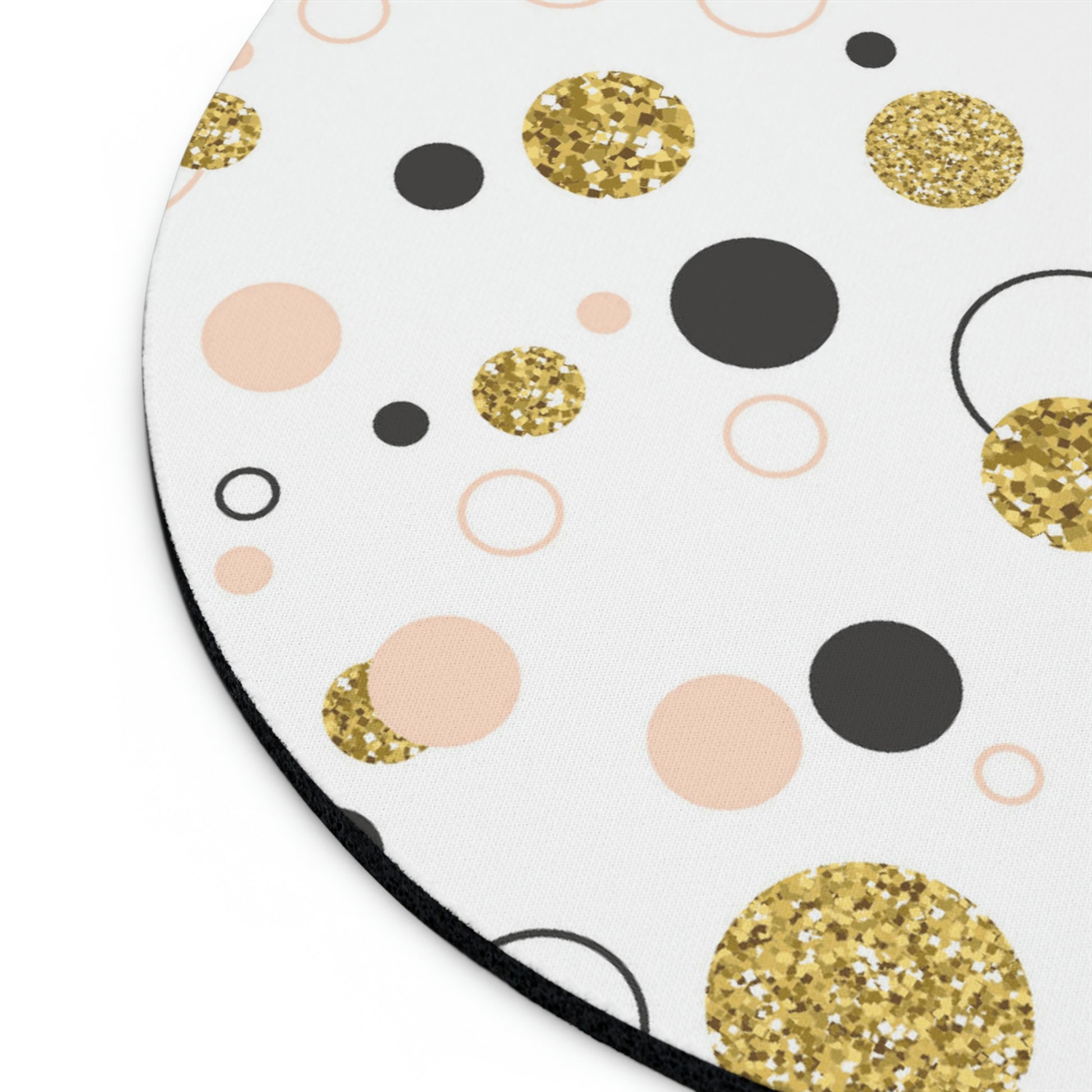 Round Mouse Pad: Retro design; 1/4" thick; Circles & Dots by Printify with a visually stunning pattern of gold glitter, black, peach, and light pink circles on a white background. Made with high-quality neoprene construction and equipped with a non-slip rubber bottom for enhanced stability during use.