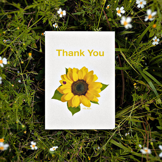 Mock up of our Thank You Card surrounded by little white flowers and greenery
