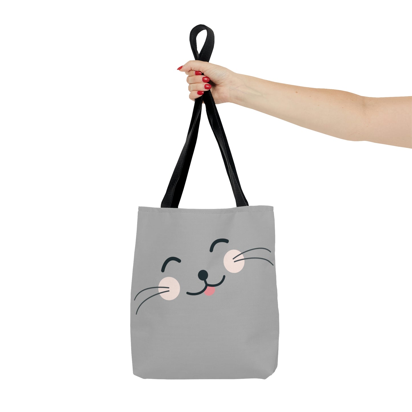 Mock up of a woman holding the small tote bag by the black handles