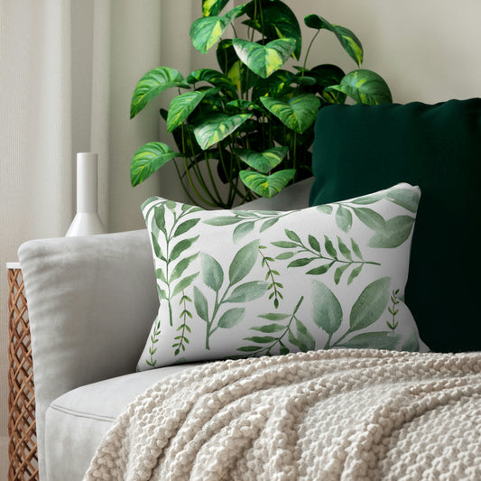 Mock up of our lumbar pillow on a sofa with a plant behind it