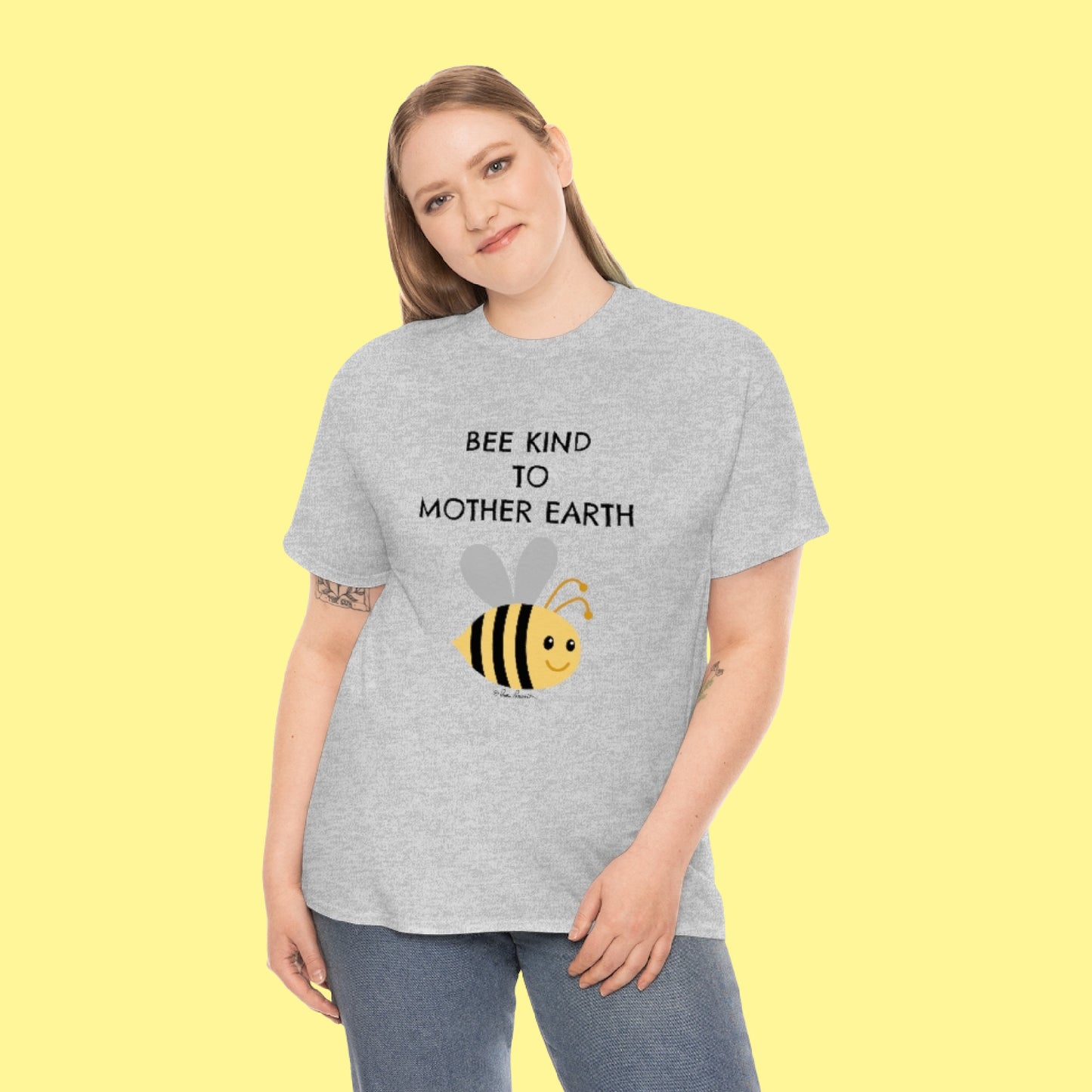 A blond-haired woman wearing our Unisex Bee-Kind T-shirt
