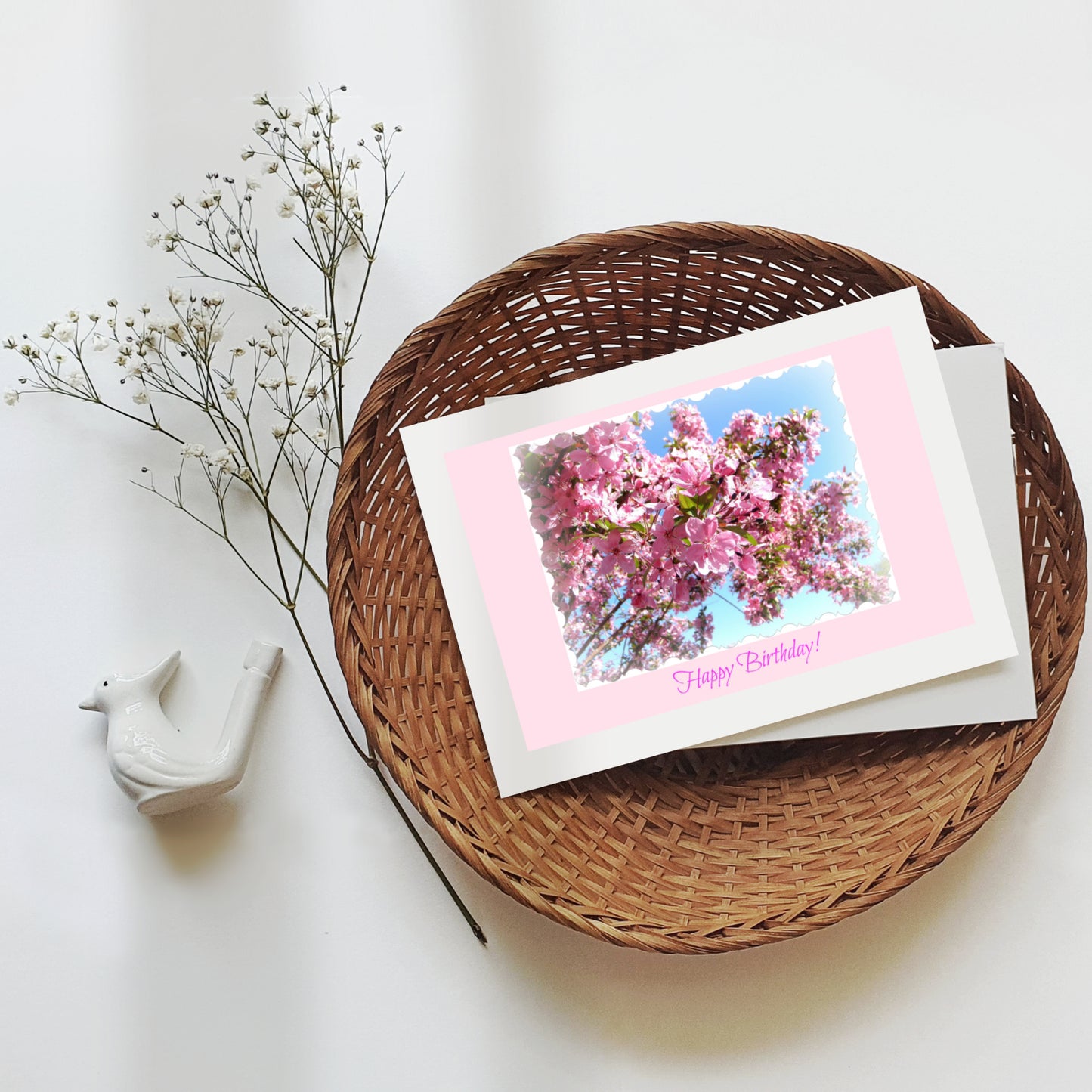 Mock up of our Feminine Birthday Card in a wicker basket