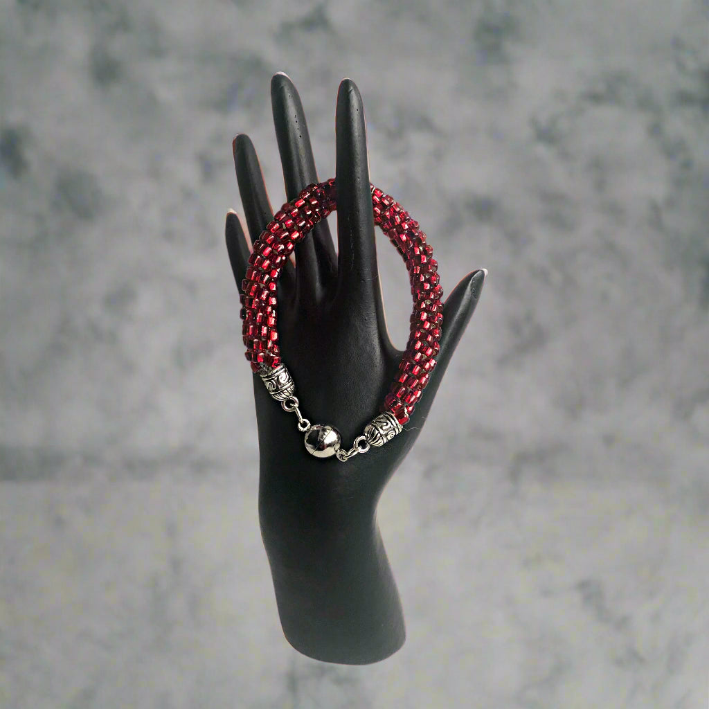 Mock up of the Read Beaded Bracelet as modeled on a prop in the shape of a hand