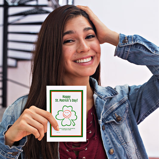 Mock up of a woman holding our St. Patrick's Card with the Happy Clover design