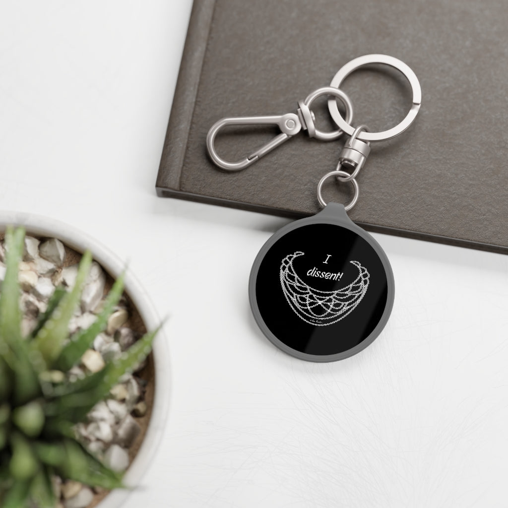 Mock up of our Key ring tag on a surface near a plant