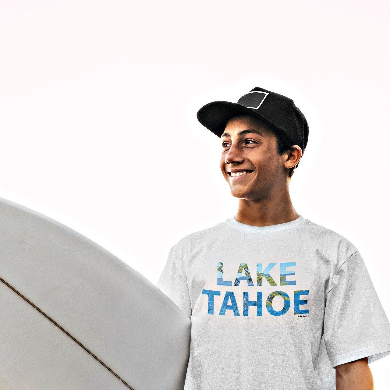 Mock up of our Lake-Tahoe Text T-shirt as worn by a man carrying a surfboard