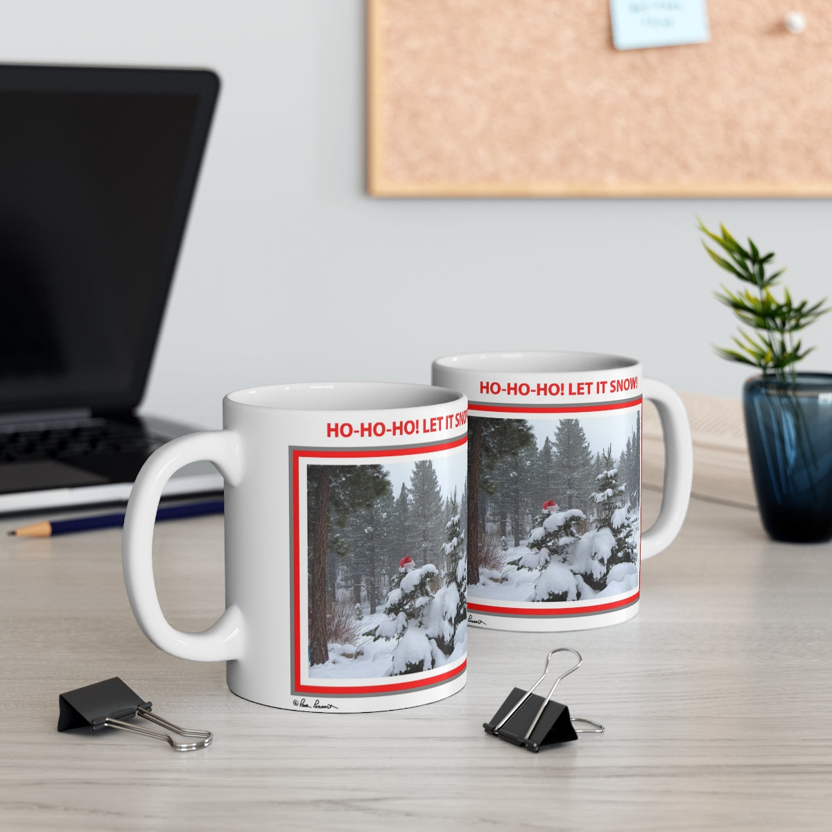 Mock up of two mugs on a surface near a computer