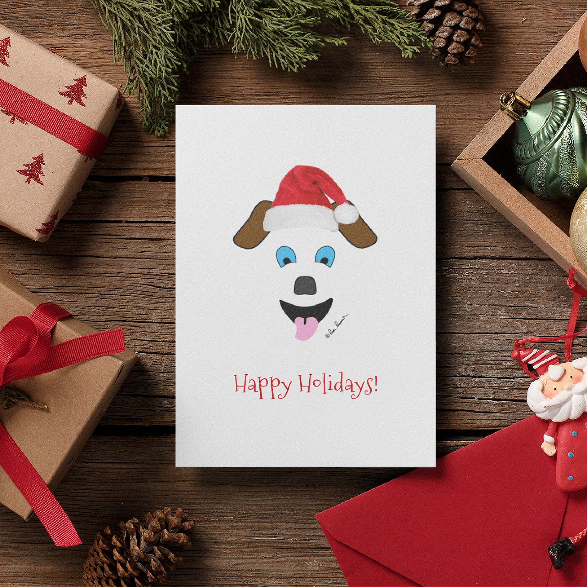 Mock up of our Santa Dog Card surrounded by holiday gift boxes and ornaments