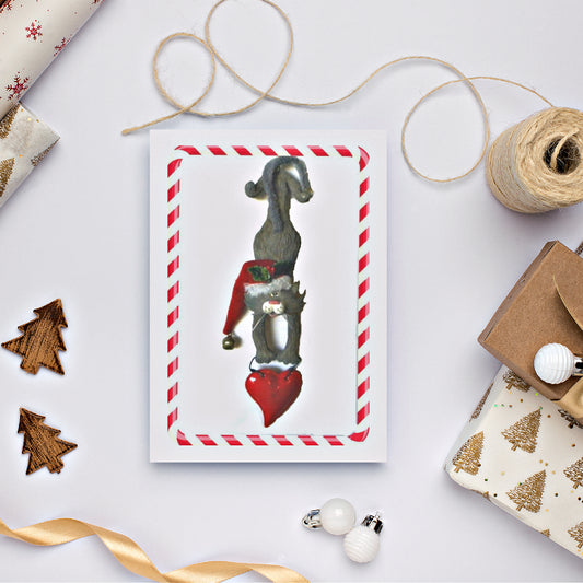 Mock up of our Santa Kitty Card on a table with holiday esssentials