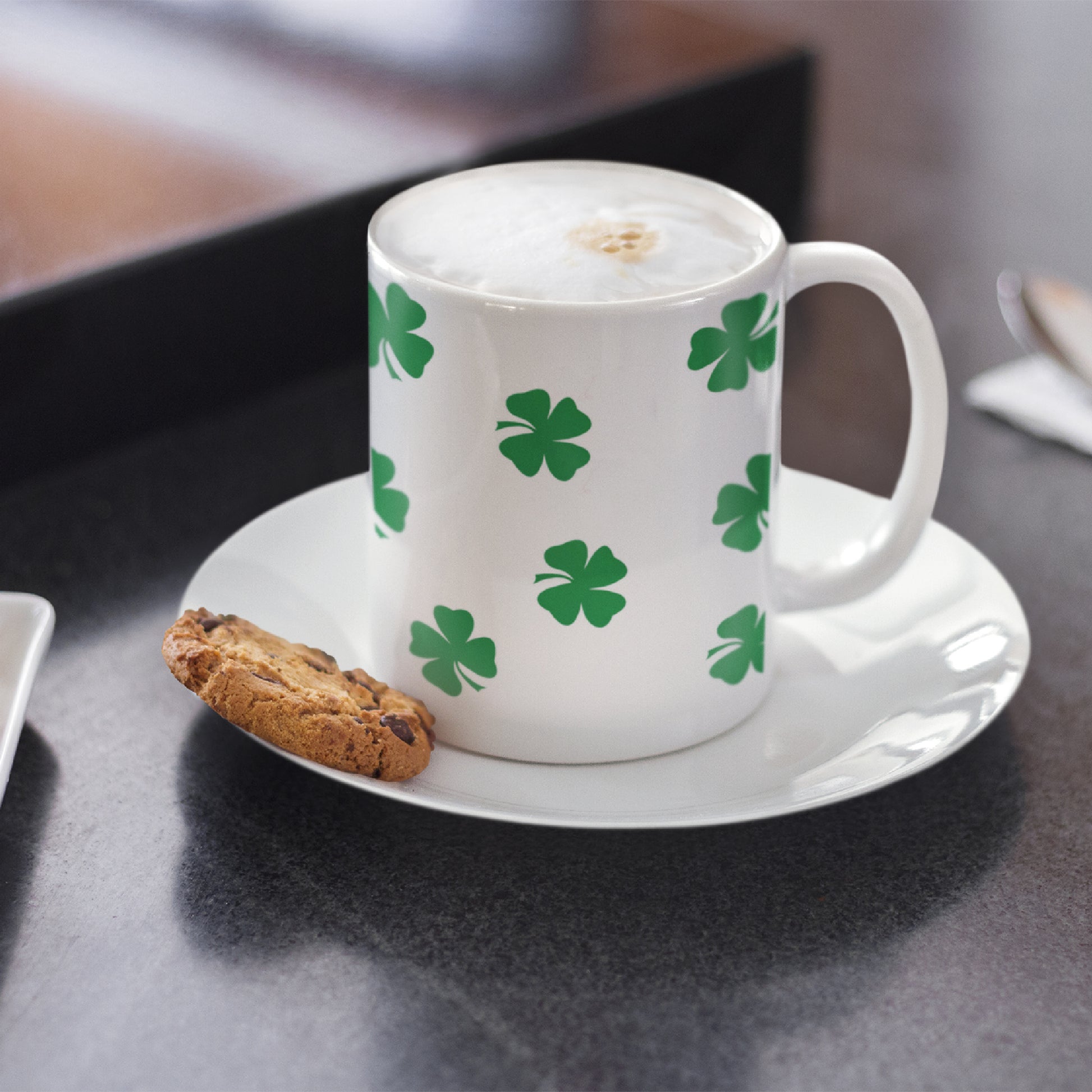 Mock up of the right side of our Mug o' Luck Mug on a plate with a cookie